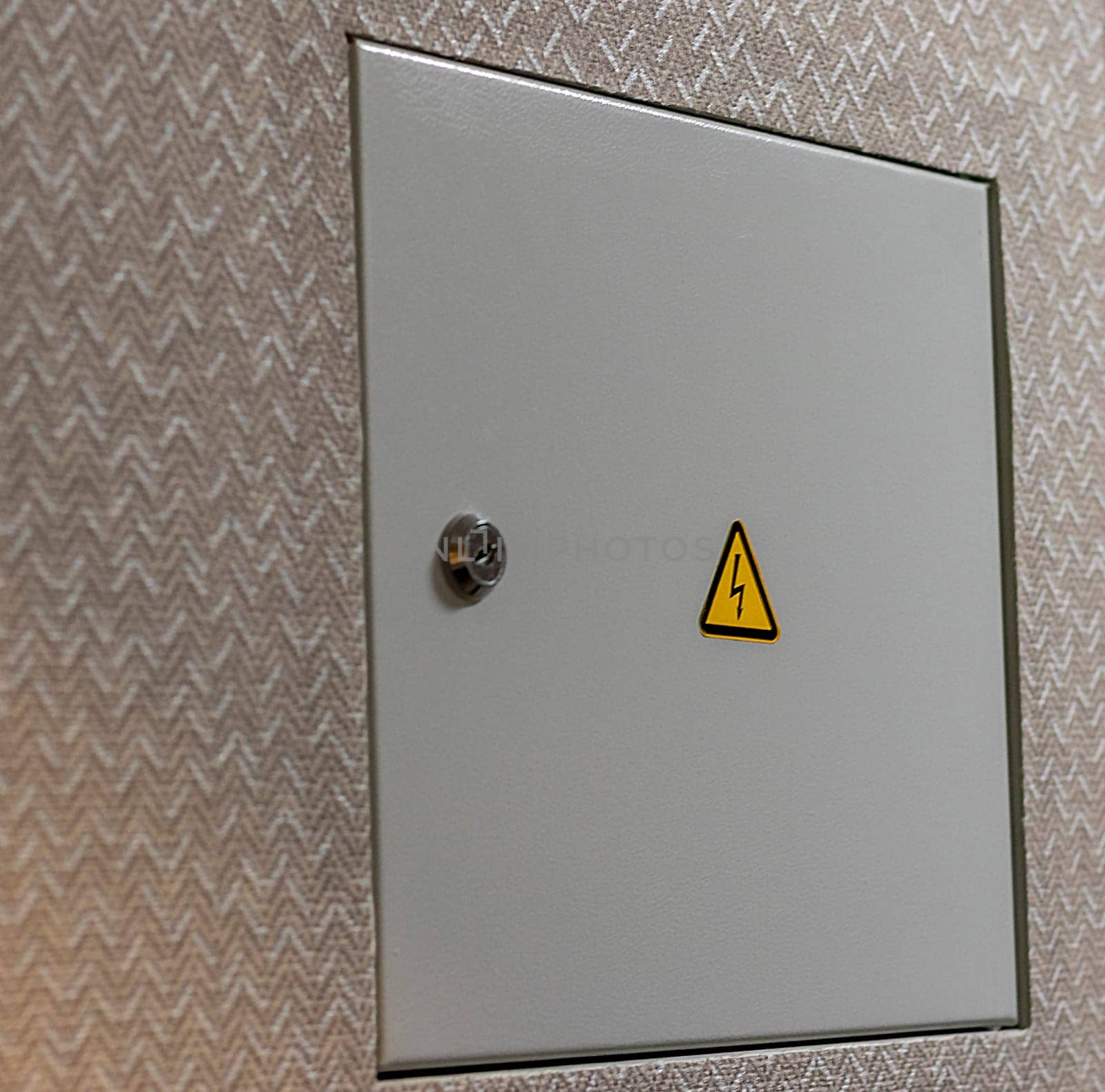 Close up shot of the door to the electric switchboard in the wall of the apartment