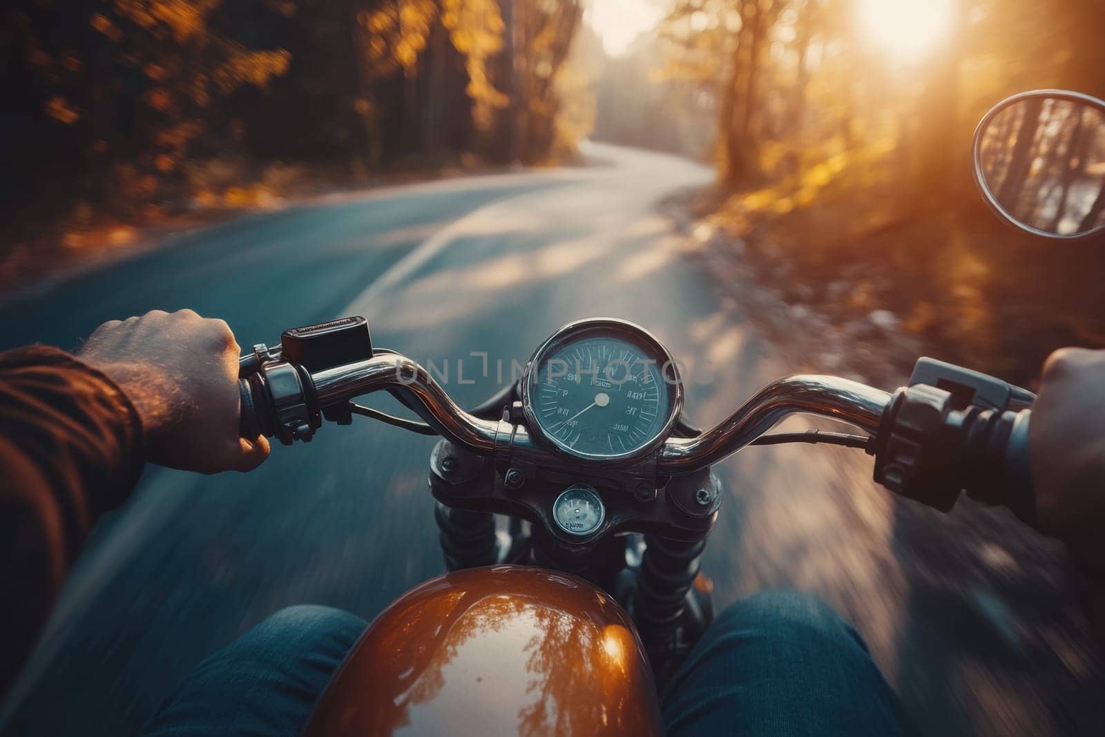 Biker riding a motorcycle on a winding road during a vibrant sunset, experiencing the freedom of the open road