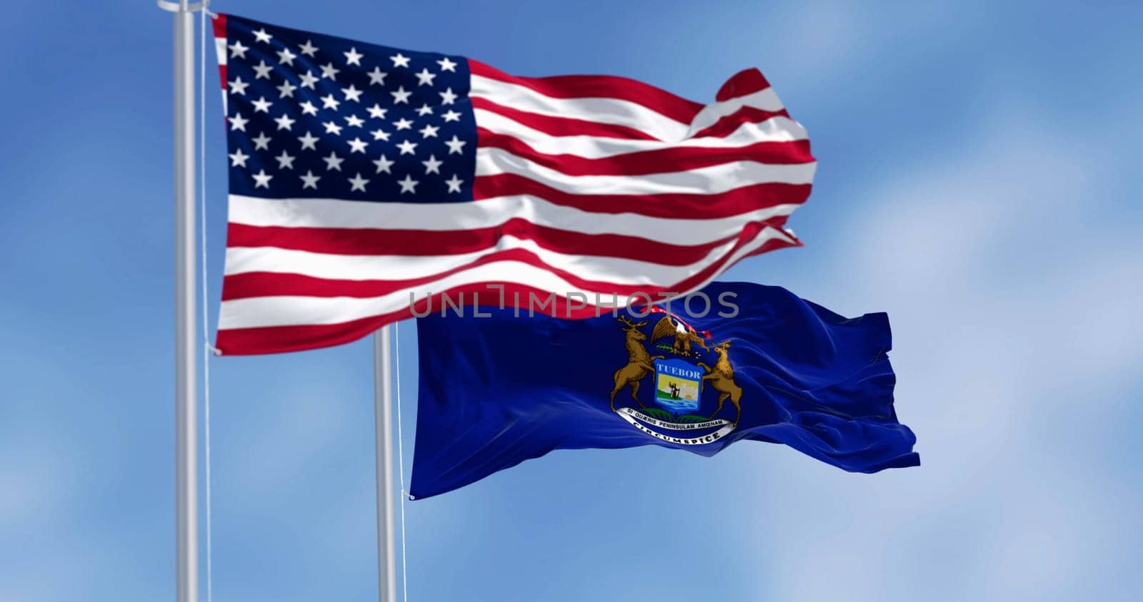 Michigan state flag and national american flag waving in the wind on a clear day. Pride and patriotism concept. 3d illustration render. Rippling fabric