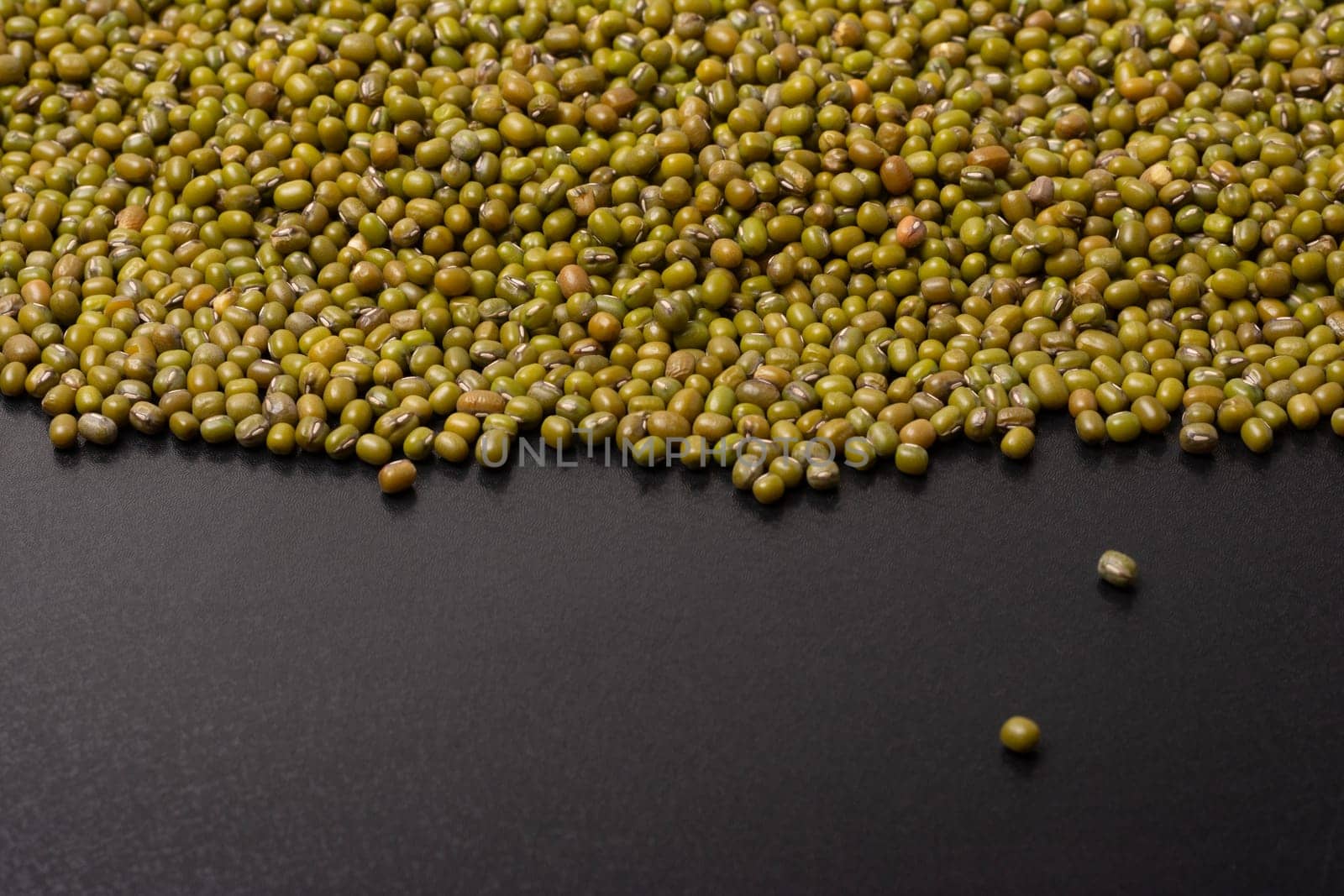Mung beans on a black background, top viewpoint