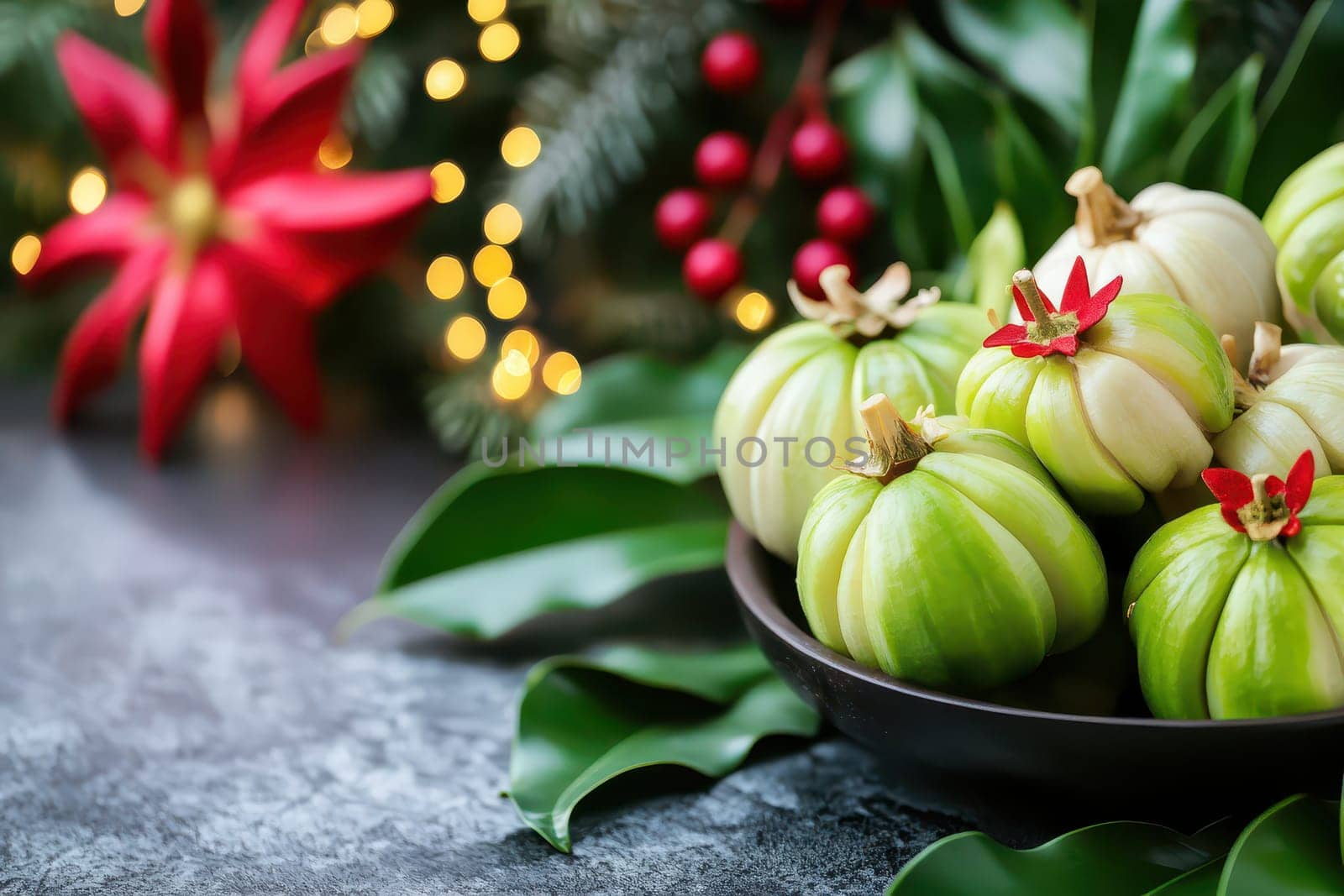 A collection of green pumpkins arranged on a dark bowl with vibrant holiday decorations and foliage in the background.