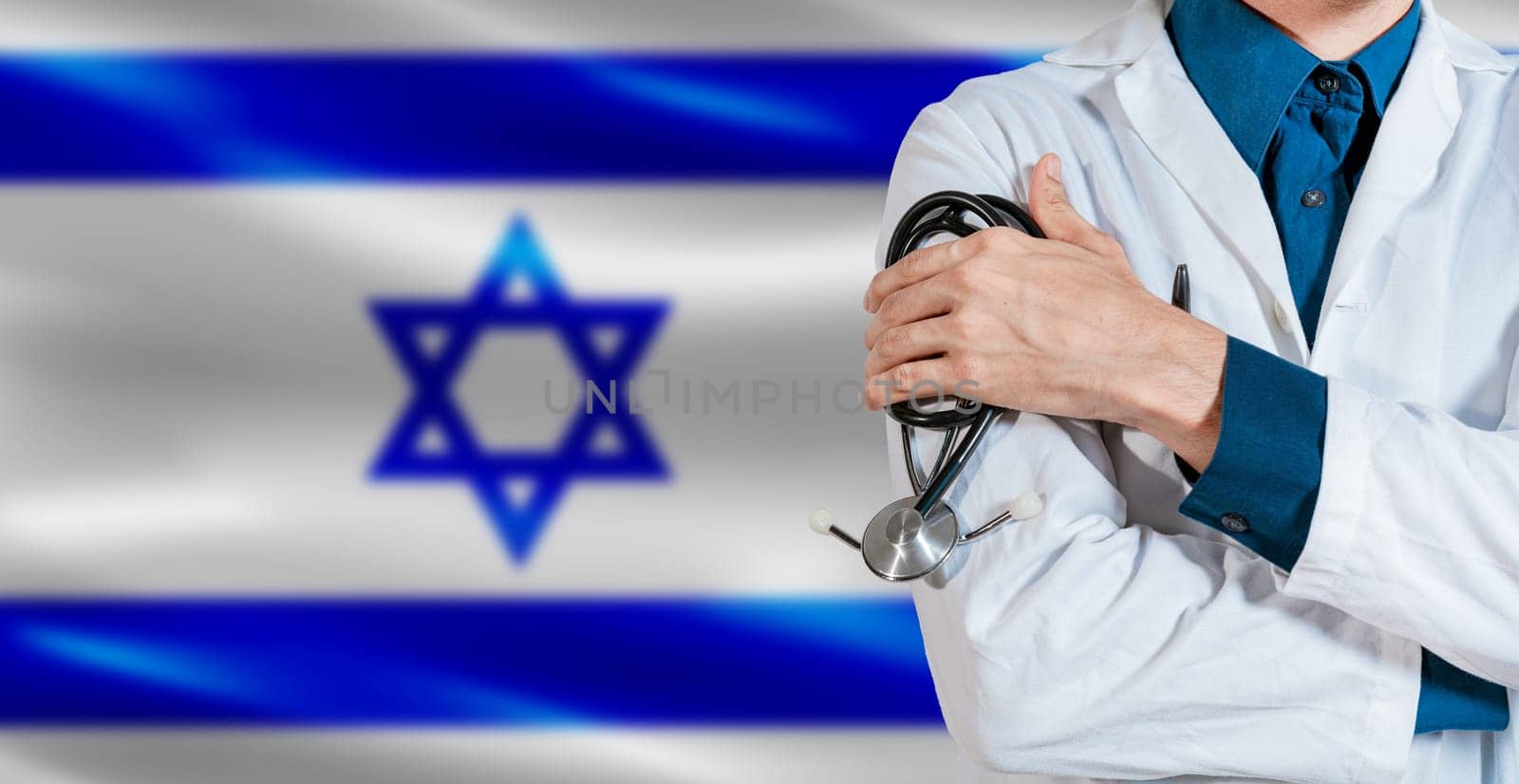 Doctor with stethoscope on Israel flag. Male Doctor holding stethoscope on Israeli flag
