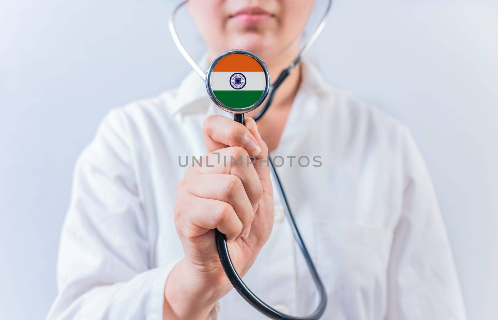 Doctor holding stethoscope with India flag. National Health System of India