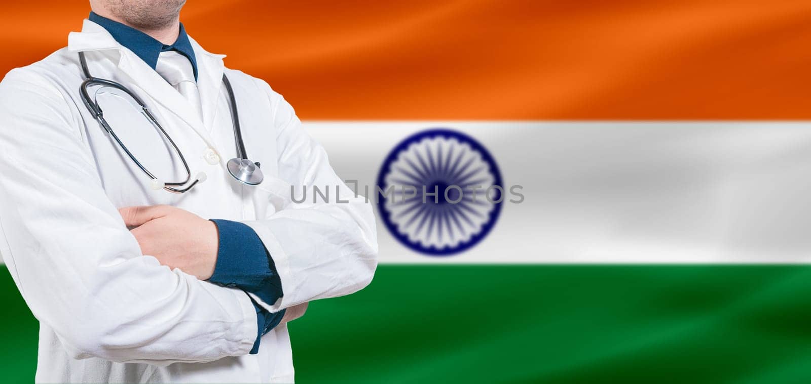 India Health and Care concept. Professional doctor on India flag. Doctor with crossed arms on India flag