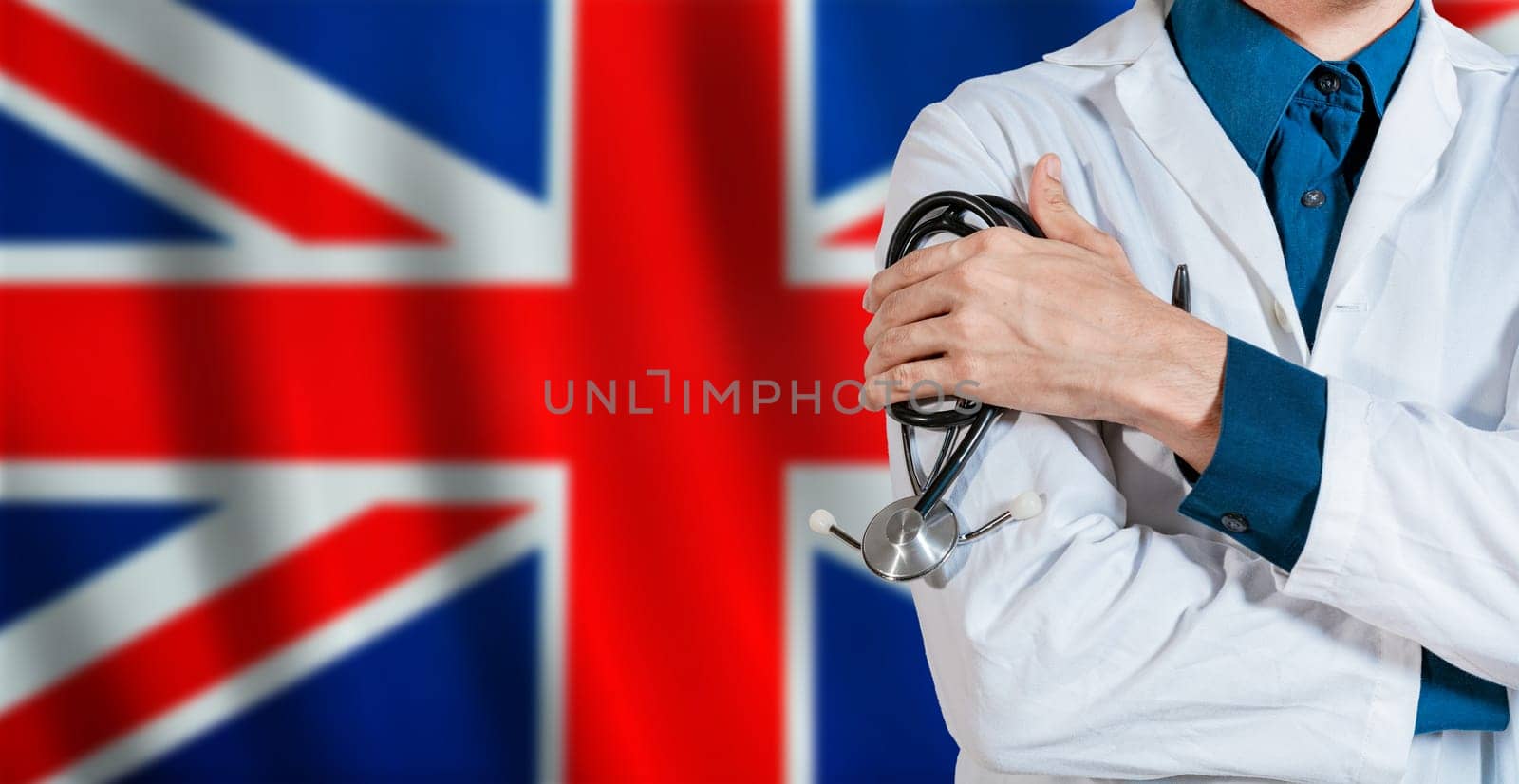Doctor with stethoscope on UK flag. Male Doctor holding stethoscope on British flag