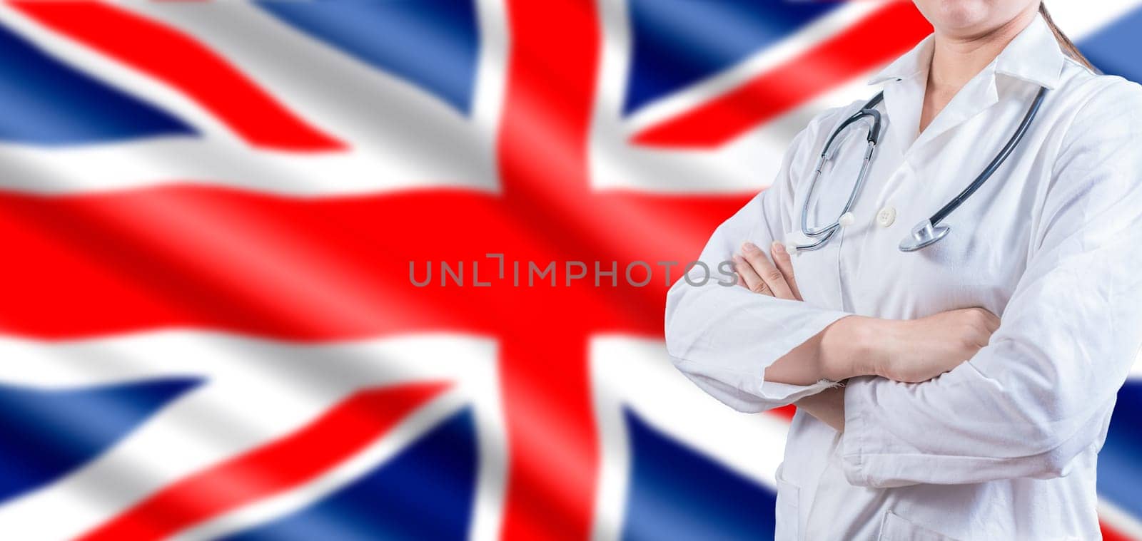 Doctor with crossed arms on UK flag. UK Health and Care concept. Female doctor on UK flag