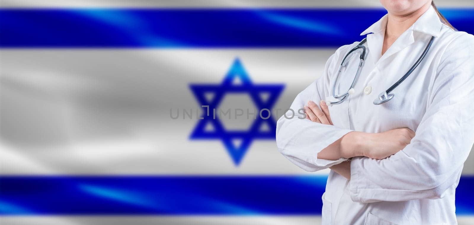 Doctor with crossed arms on Israel flag. Israeli Health and Care concept. Female doctor on Israel flag