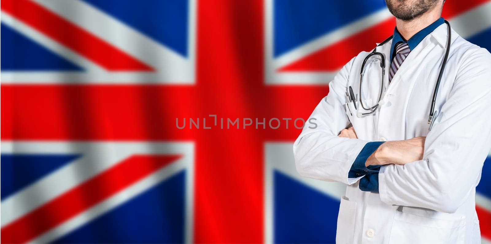 Doctor with crossed arms on British flag. UK Health and Care concept. Professional doctor on British flag