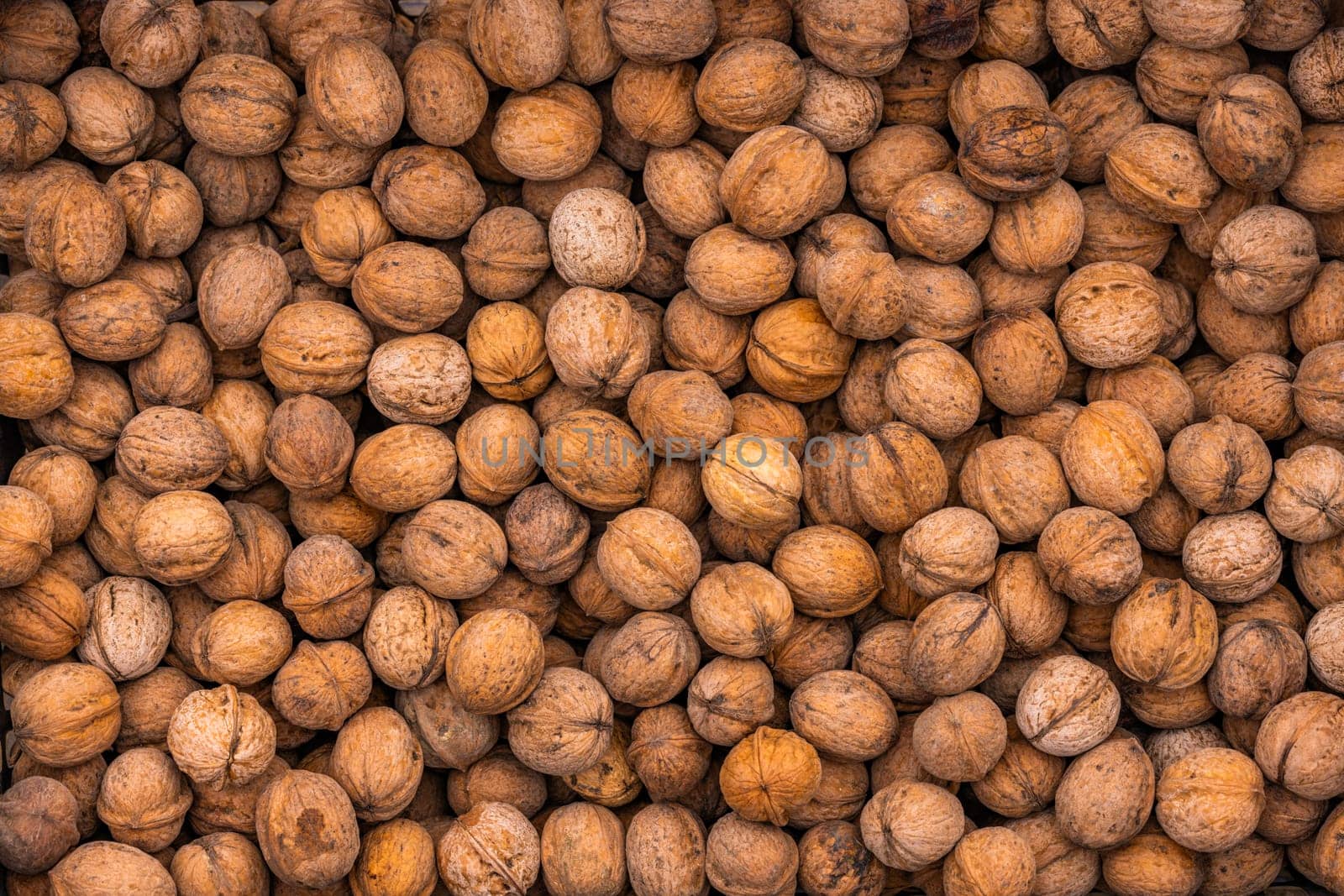 pile of unpeeled walnuts with high angle view, full-frame texture and background
