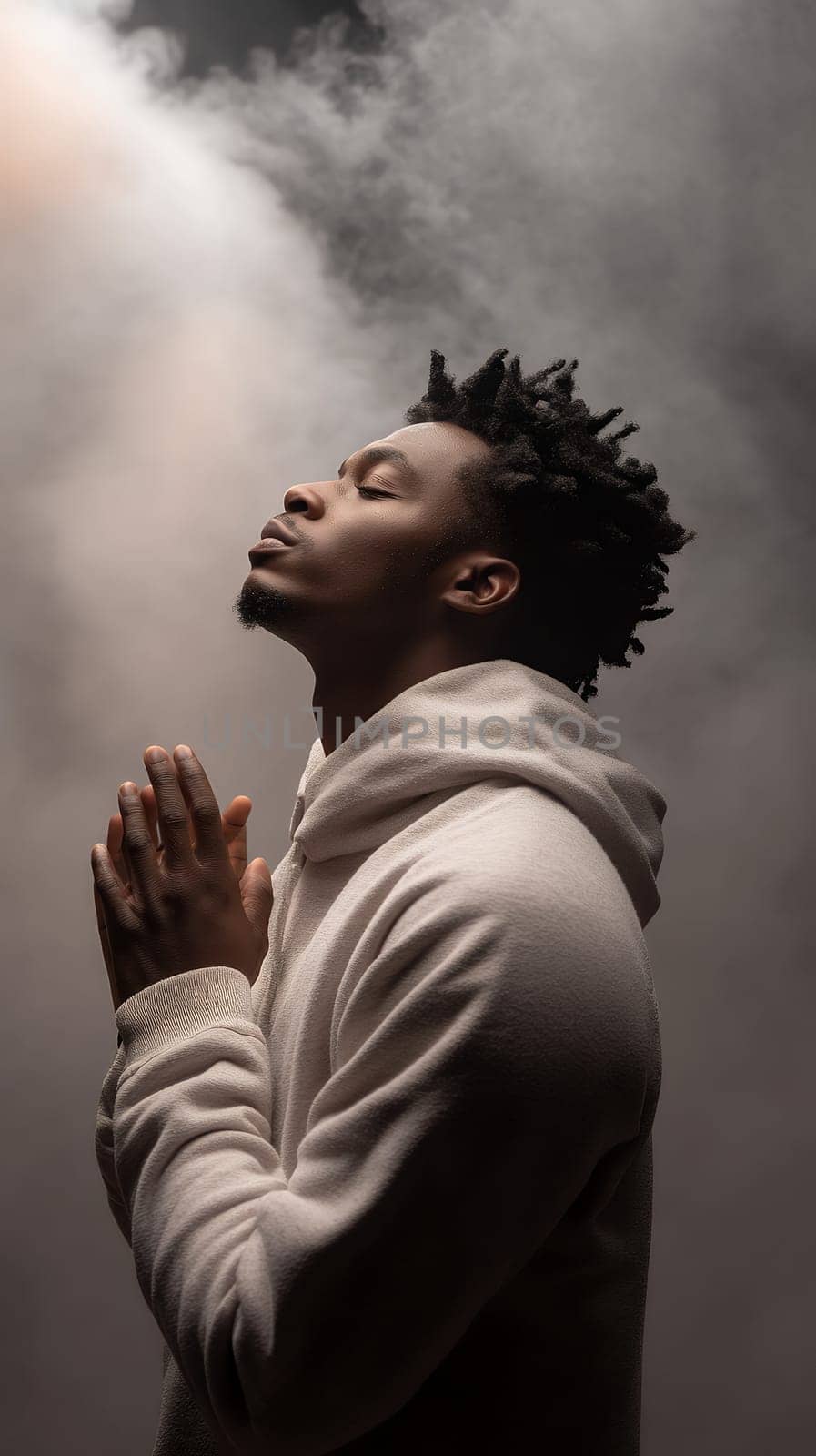 A contemplative man with hands clasped in prayer, surrounded by a misty, ethereal atmosphere.