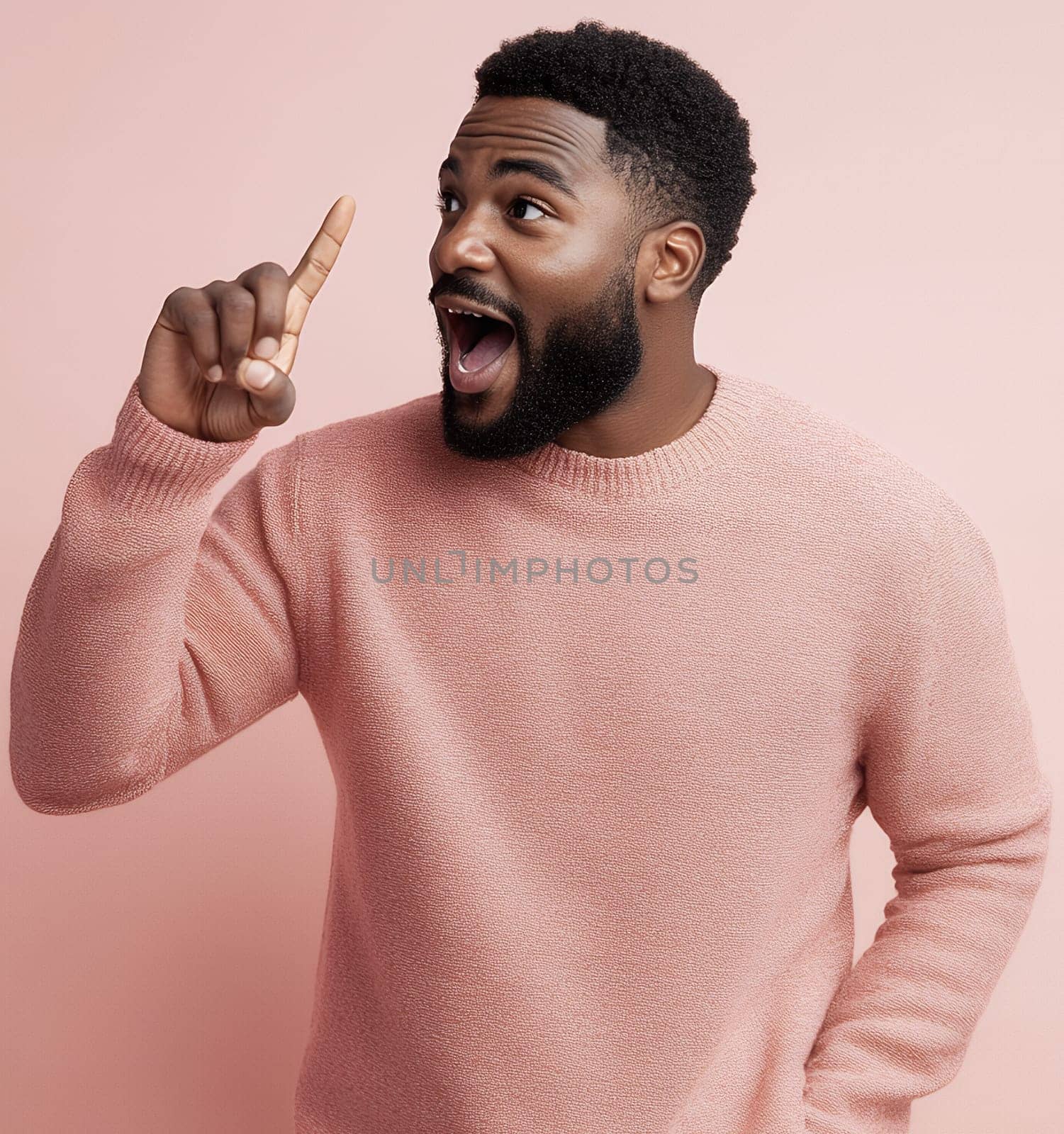 Excited man pointing upwards with an expression of realization against a pink background.