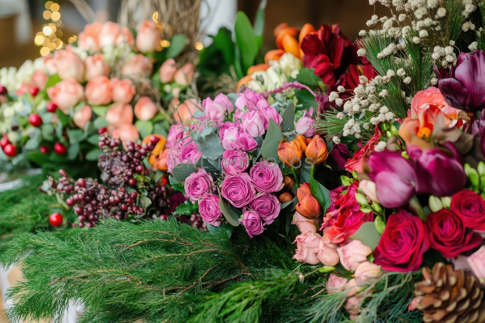 Colorful bouquets with roses and various flowers create a vibrant display perfect for a spring event or festive occasion.