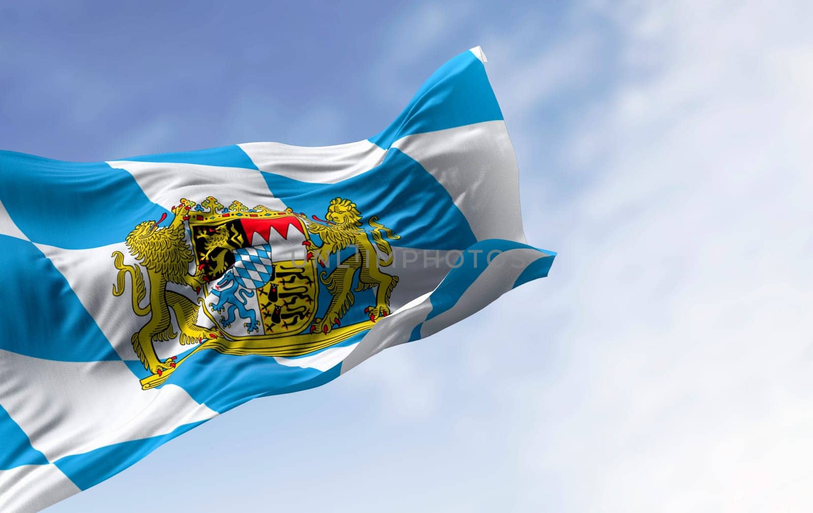 Bavarian flag waving in the wind on a clear day. Bavaria is a state in the south-east of Germany. 3d illustration render. Fluttering fabric.