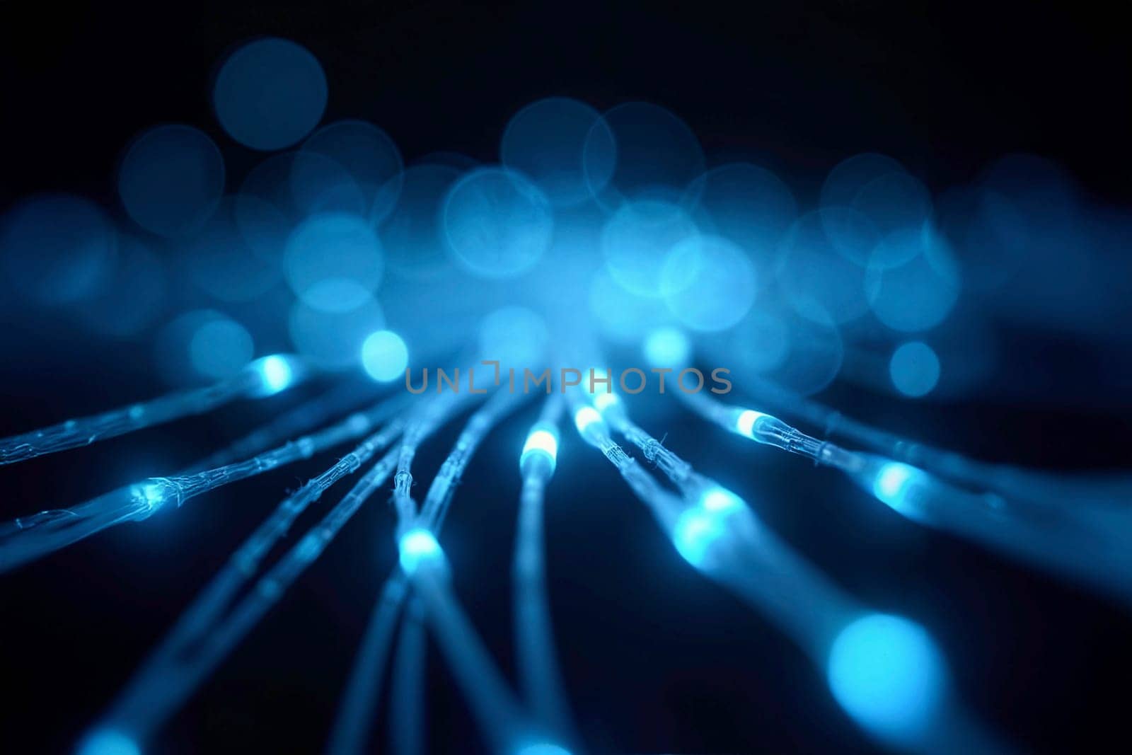Abstract close-up view of illuminated blue optical fibers against a dark background. Concept of fast data transmission, advanced technology, and modern communication networks.
