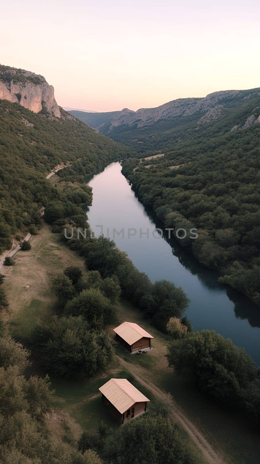 A stunning river valley at sunset, with lush green hills and a tranquil river reflecting the evening light.