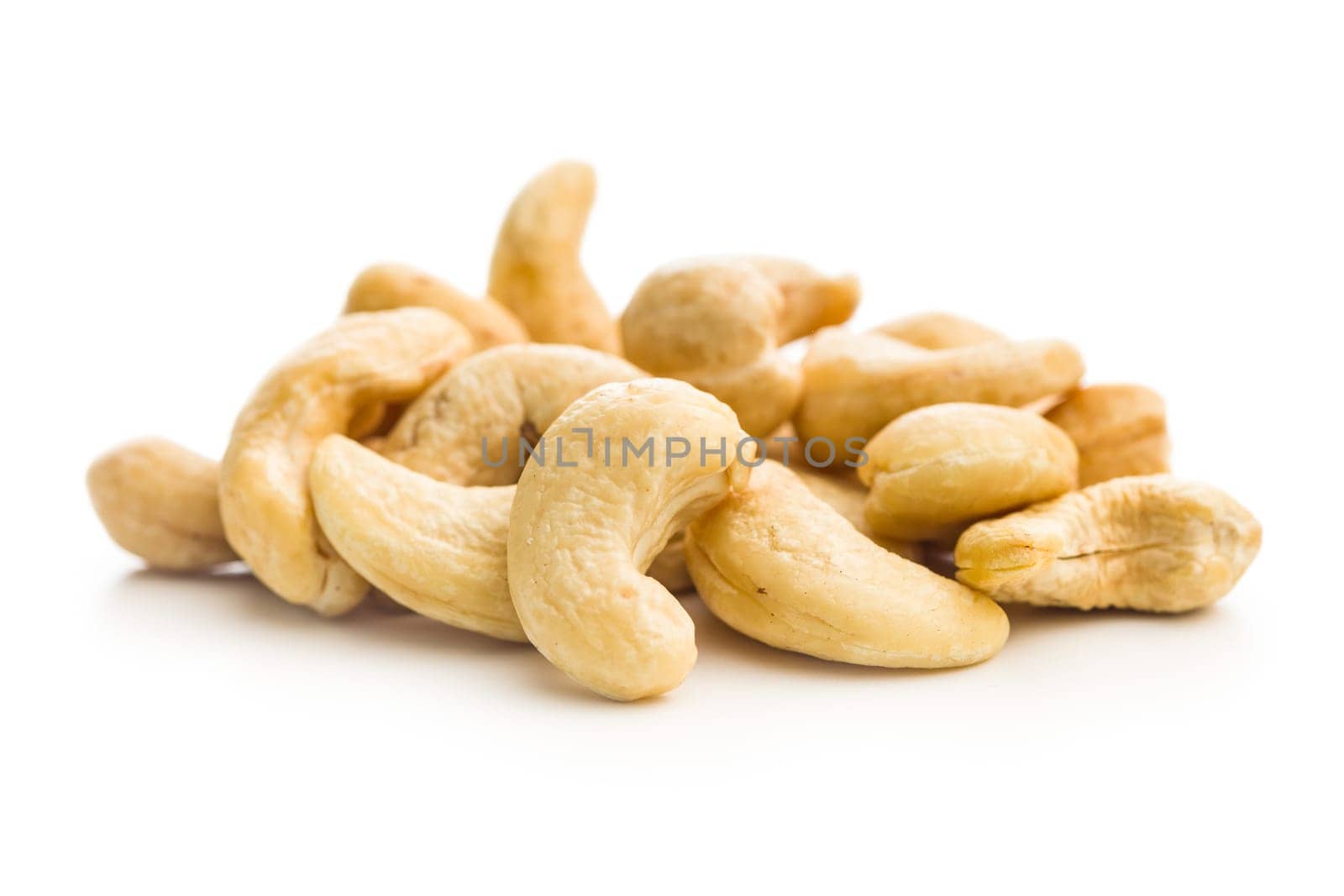 Roasted cashew nuts isolated on a white background.
