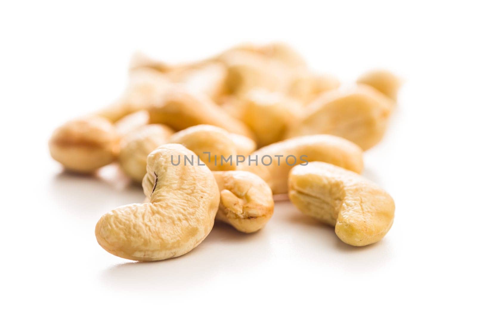 Roasted cashew nuts isolated on a white background.