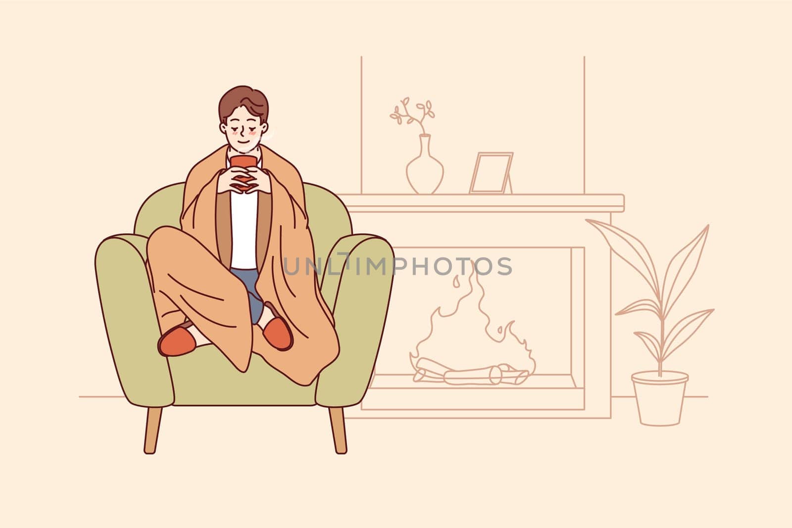 Man feels comfort and harmony sitting by fireplace with blanket on shoulders and cup of hot coffee in hands. Guy enjoys comforts of home and apartment is cozy, allowing him to relax on winter evenings