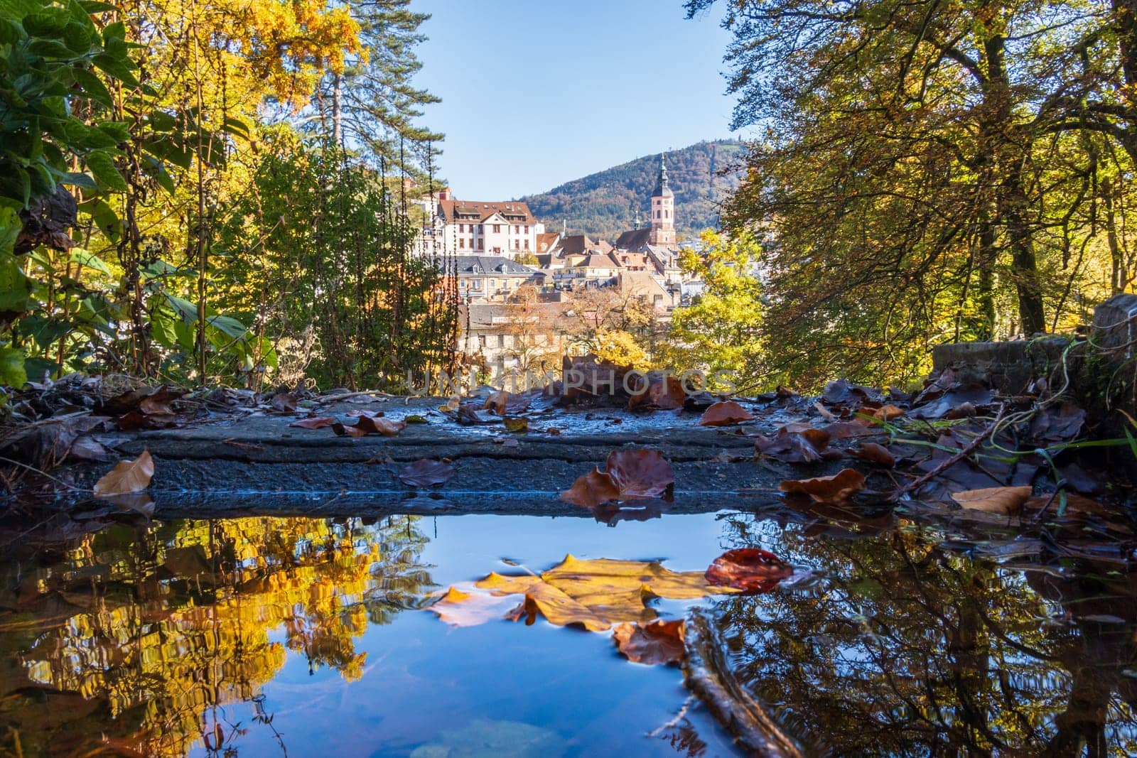 Autumn view of the old spa town of Baden-Baden reflected in a fountain, Baden-Württemberg, Germany