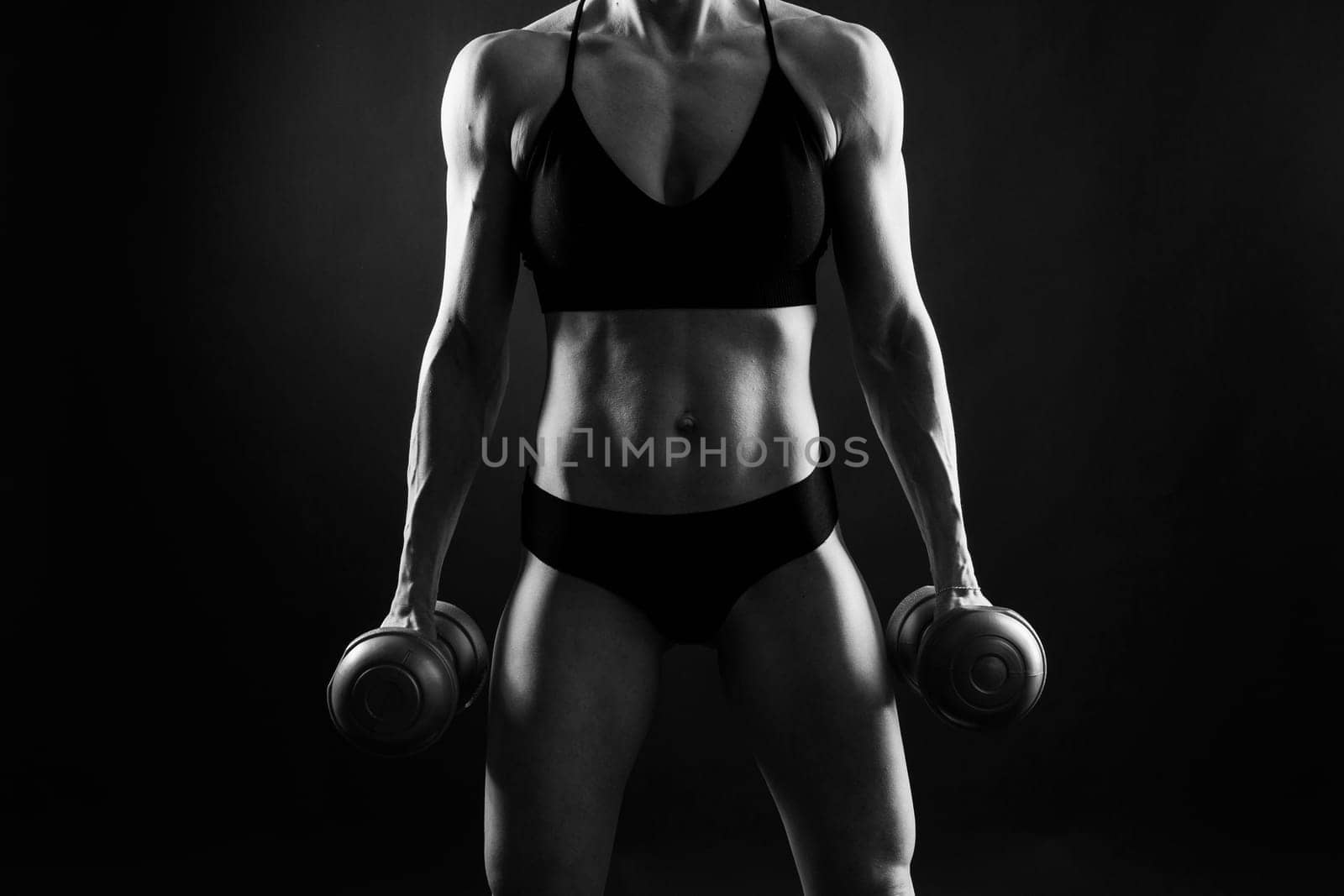 Back view of female model posing in a studio and demonstrating comfortable activewear.