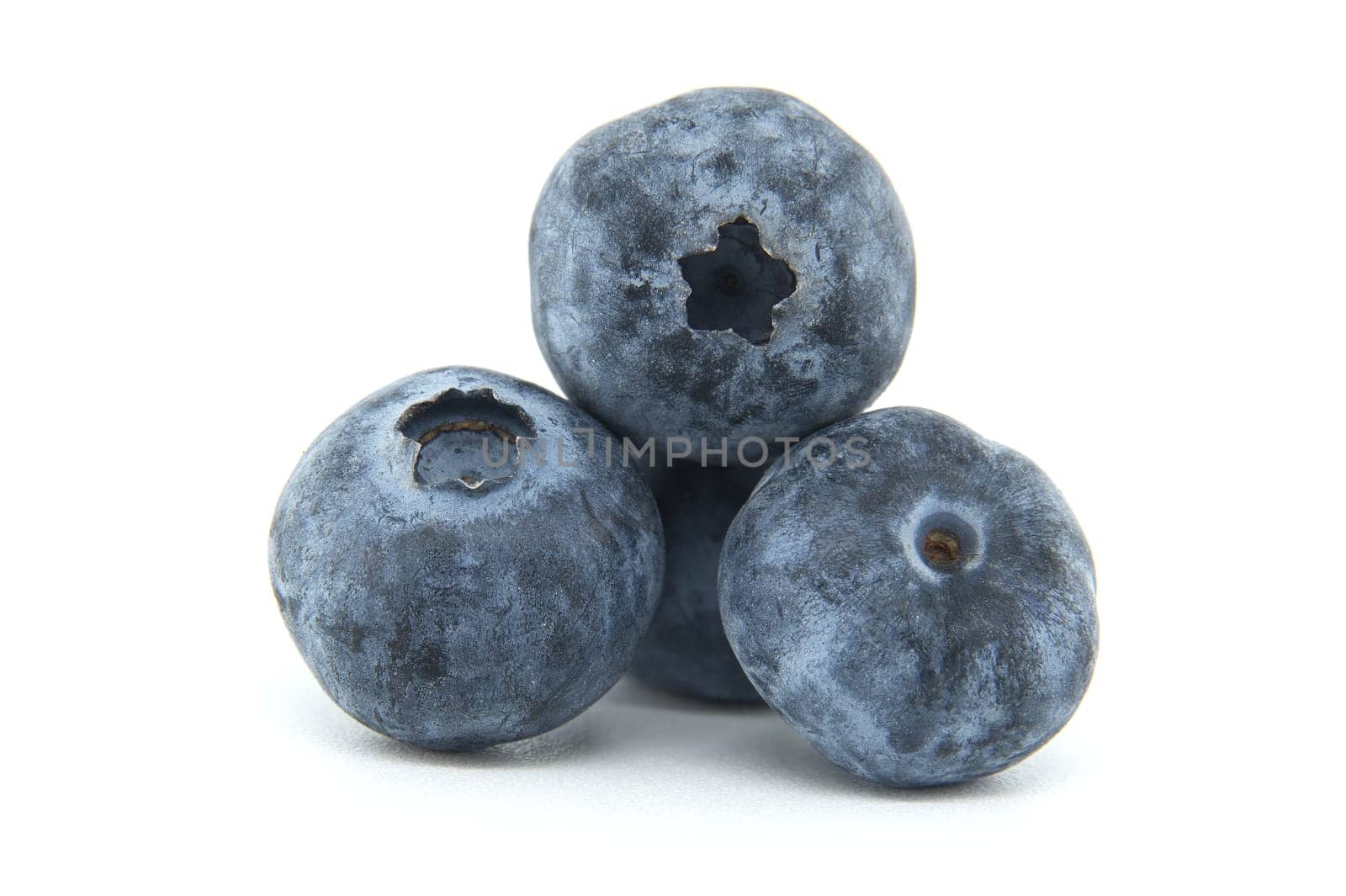 A close-up image of three fresh blueberries stacked together against a white background, highlighting their vibrant color and natural texture