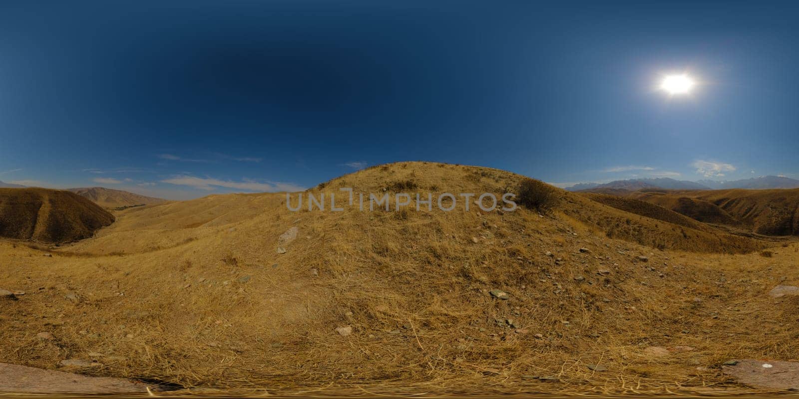 Full Spherical panorama of dry grass hills at sunny autumn day with clear blue sky above in equirectangular projection