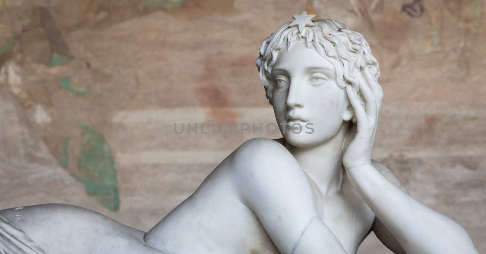Pisa, Italy - 29 June 2023: sad statue in cemetery. Vintage white marble sculpture, woman sorrow