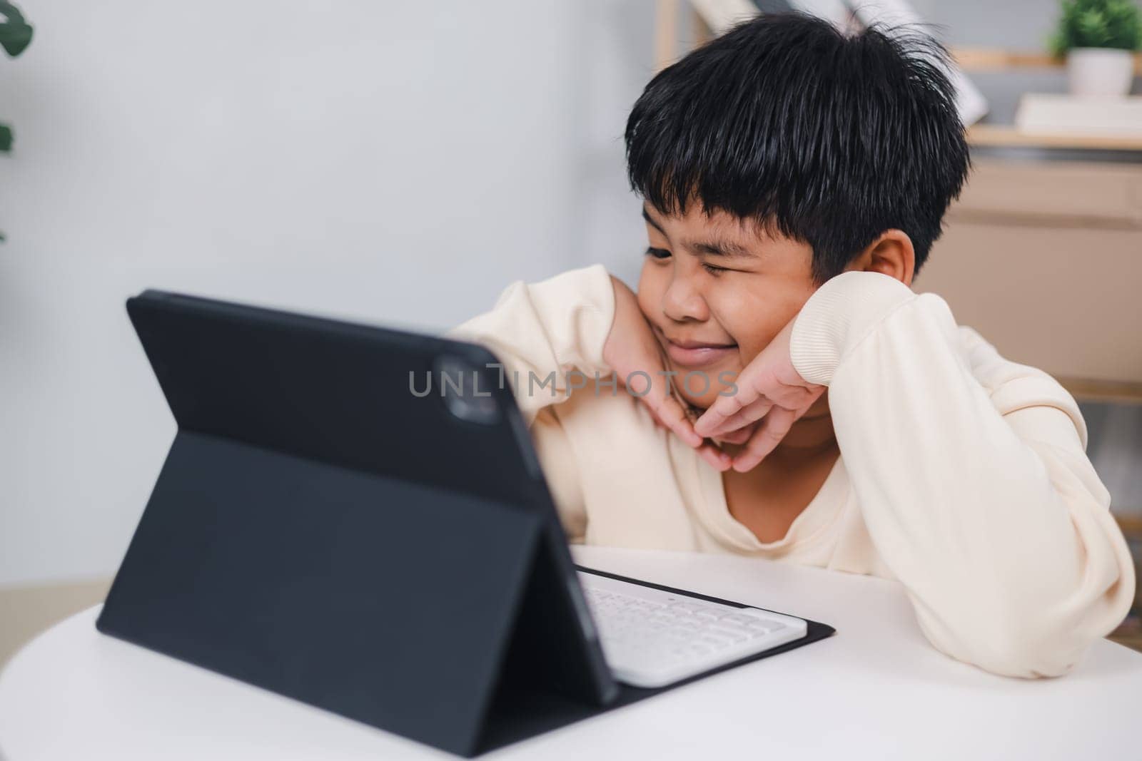 Asian boy student using tablet learning, Educational of tech concept, Staying at home, Presenting a modern educational way of life, Virtual internet online class from school teacher.