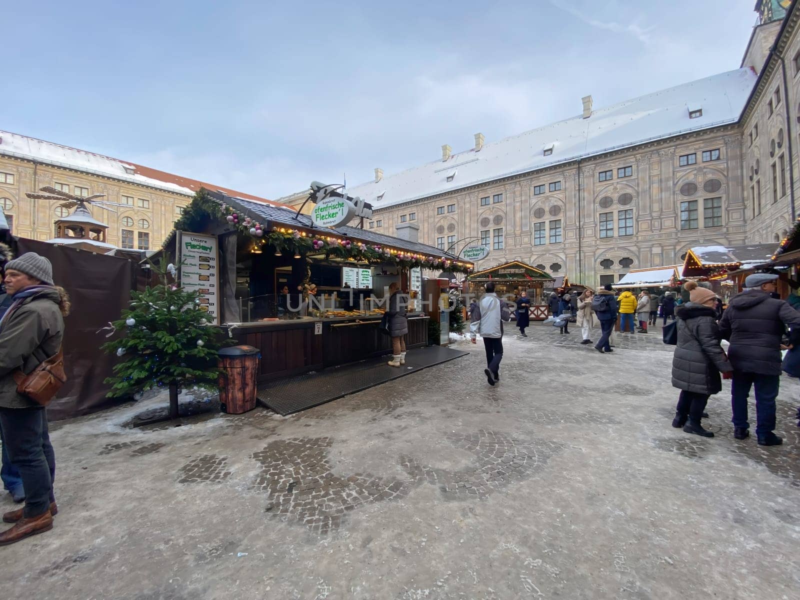 Munich, DE, Dec. 19 2022  Christmas market in the courtyard of the Munich Residenz, featuring festive stalls, decorations, and visitors enjoying the seasonal atmosphere