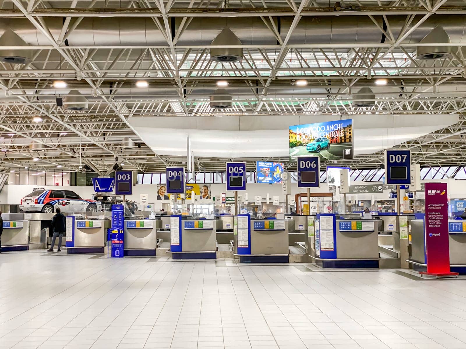 Turin, IT, Nov. 19 2024  Check-in counters at Turin Caselle Airport, officially named after Sandro Pertini, showcasing a modern terminal layout and travel services.