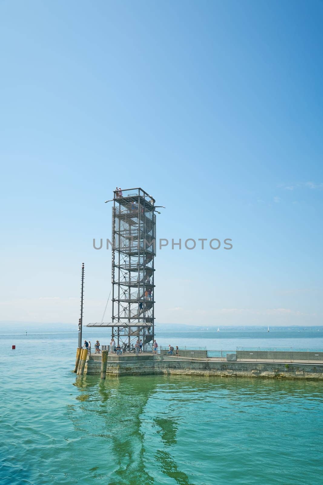 The Moleturm with some tourists at the harbor pier near Friedrichshafen on Lake Constance, Bodensee in Germany