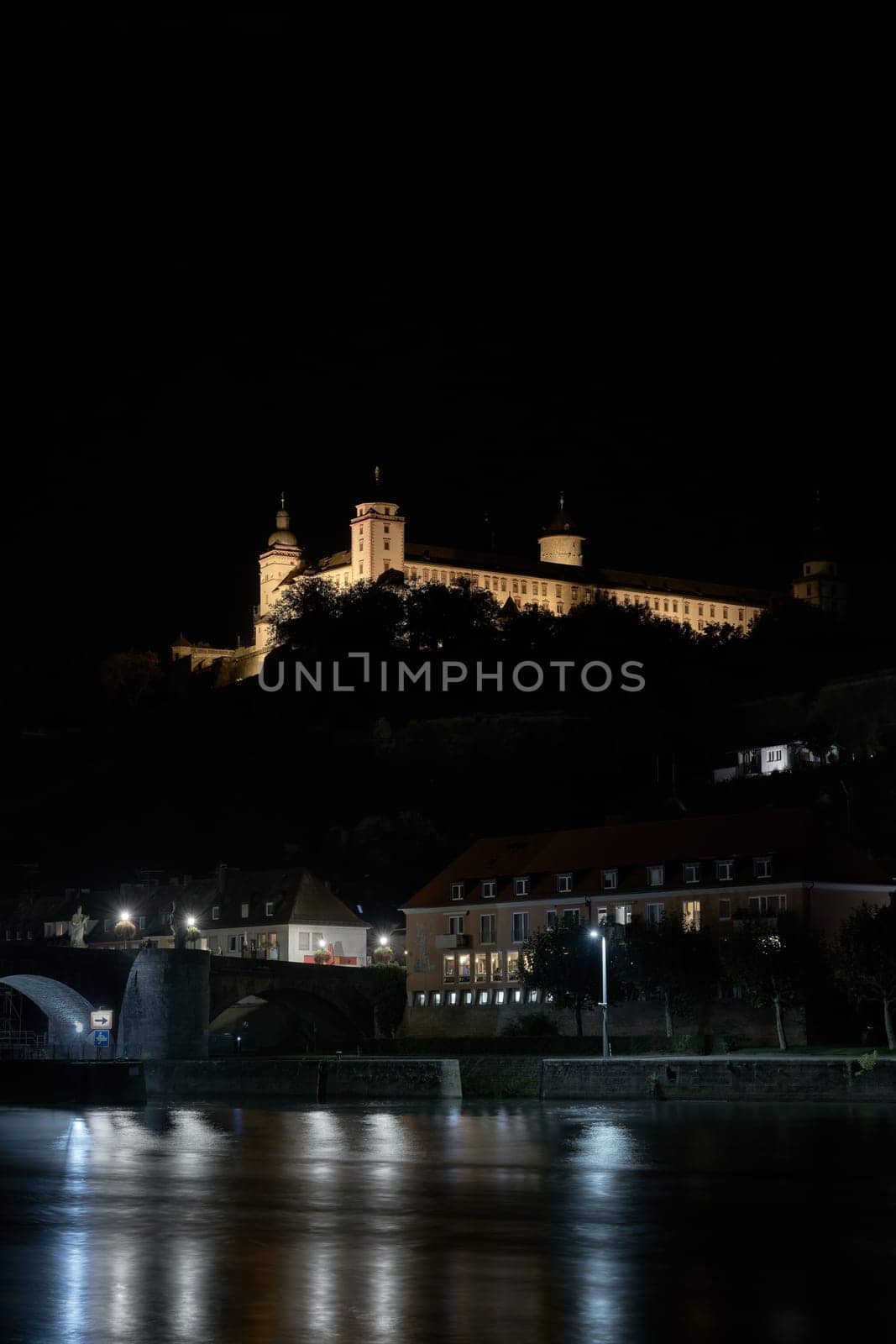 Illuminated Marienberg Fortress above the city of Wuerzburg on the River Main in Germany at night