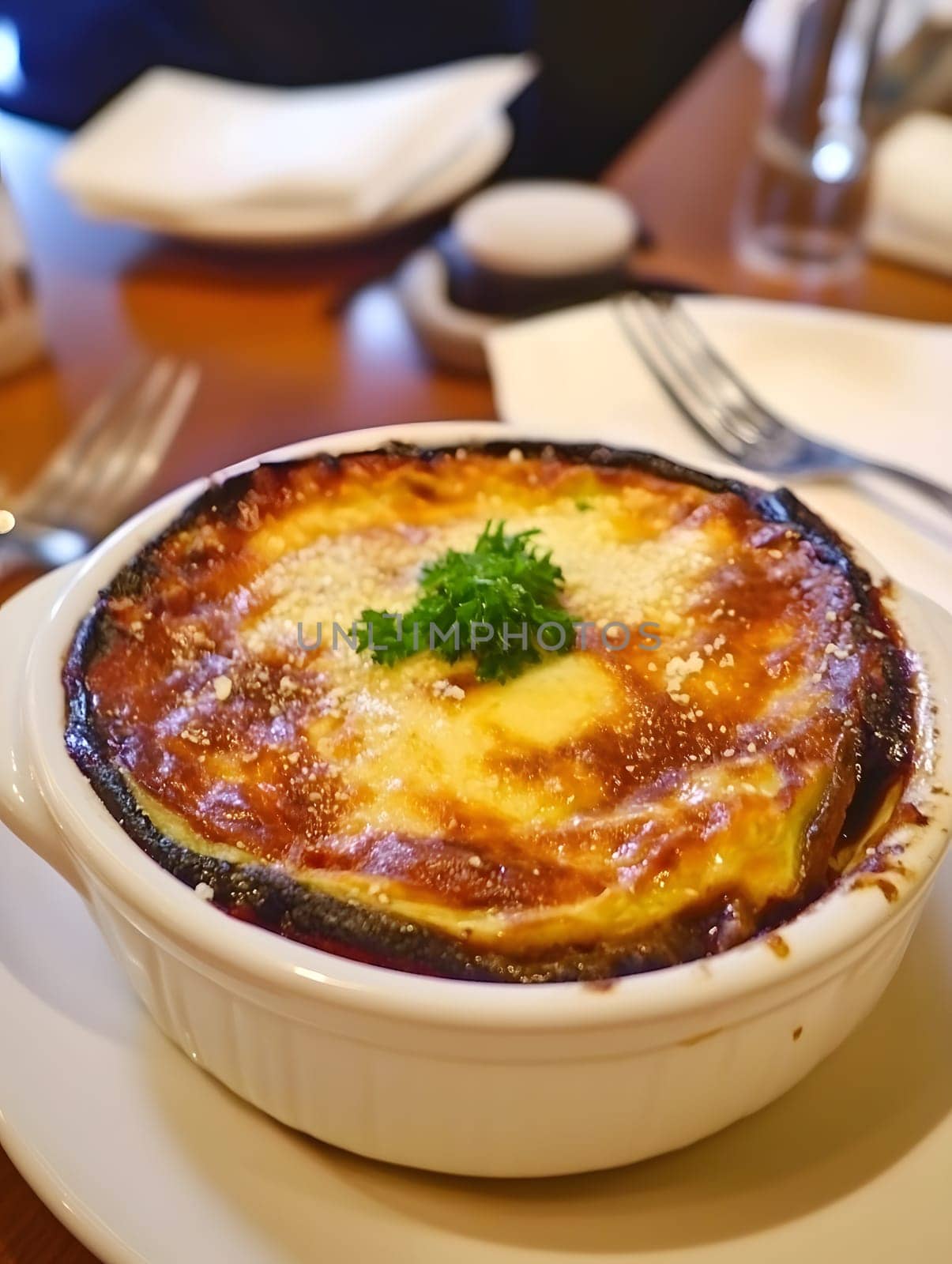 Cooking a fresh homemade moussaka recipe meal. Tasty Dish of Food with cheese