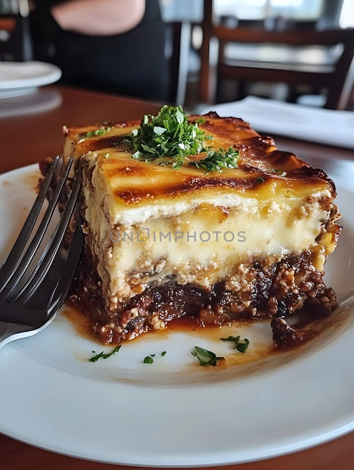 Cooking a fresh homemade moussaka recipe meal. Tasty Dish of Food with cheese