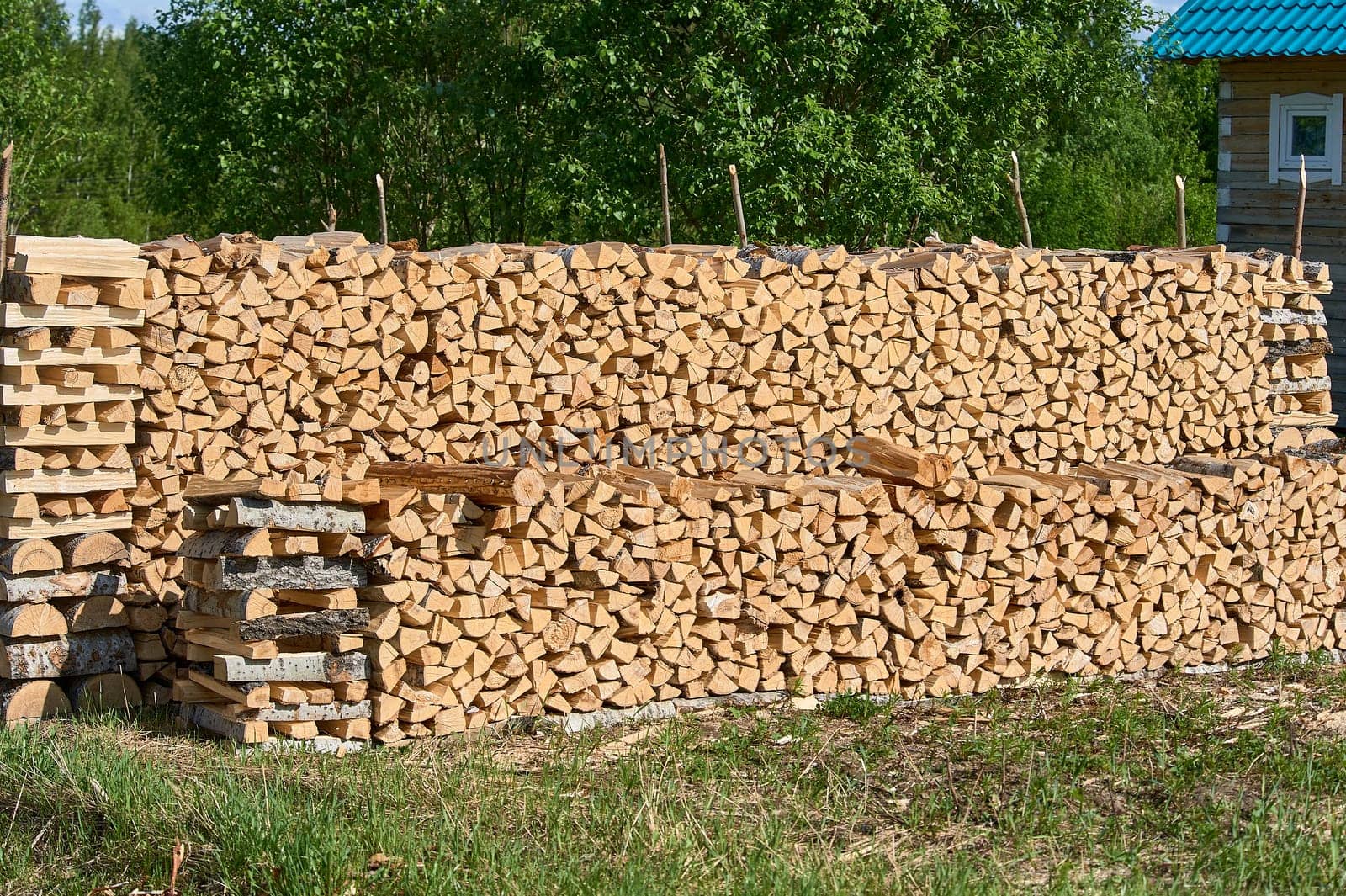a large supply of chopped wood laid in a fire. High quality photo