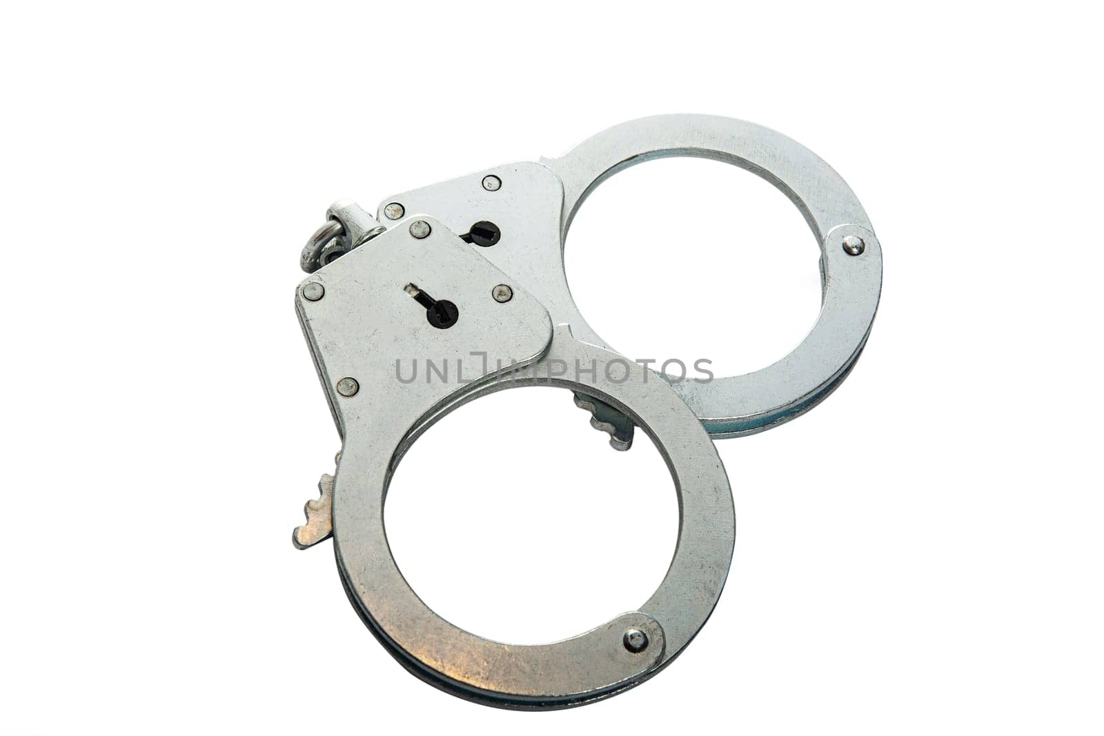 Metal handcuffs on a white isolated background, copy space. High quality photo