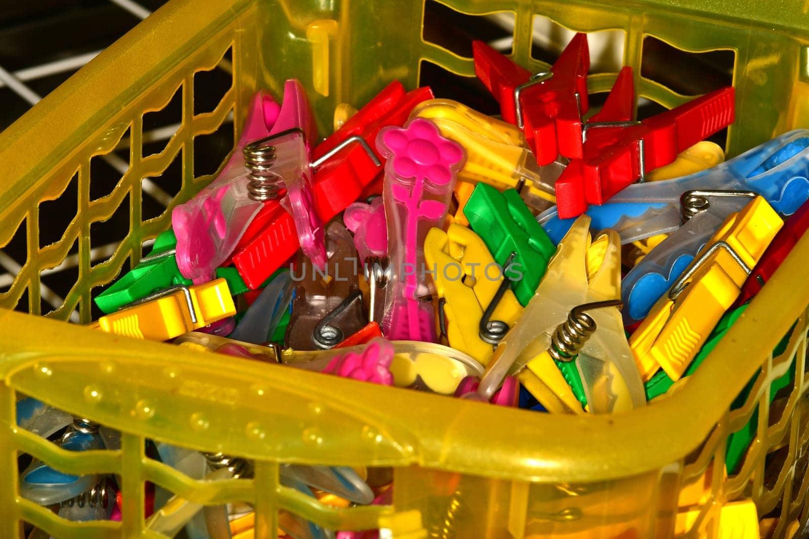 colorful clothespins in a basket in a closeup