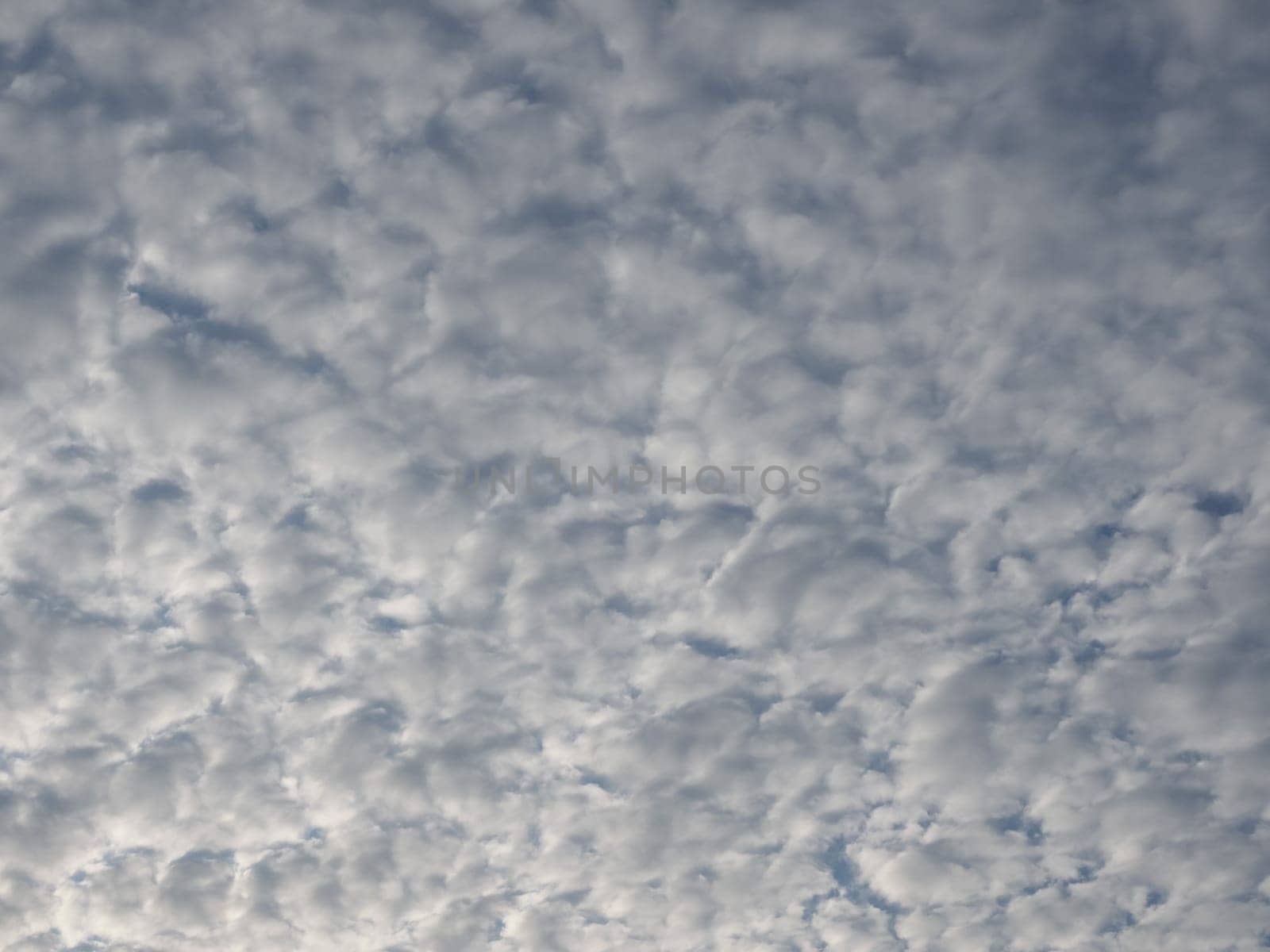 dramatic overcast stormy sky cloudscape with white clouds useful as a background