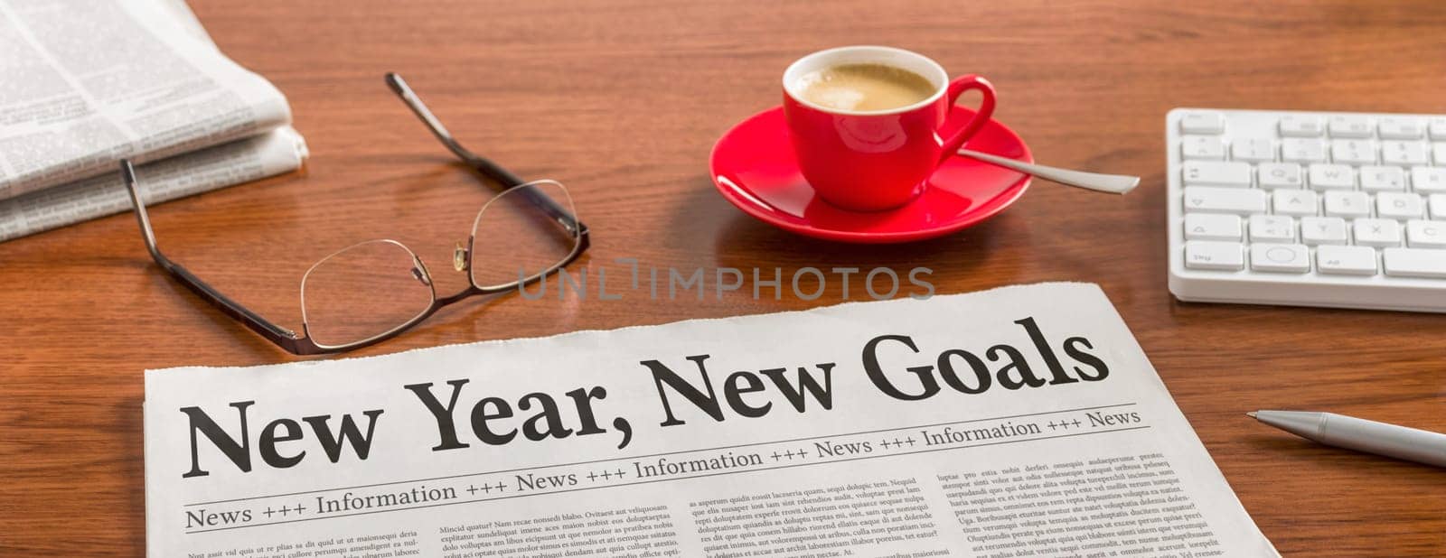 A newspaper on a wooden desk - New year, new goals