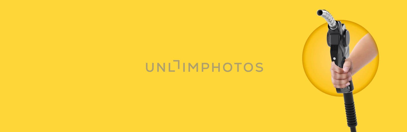 Hands holding Fuel nozzle on yellow background