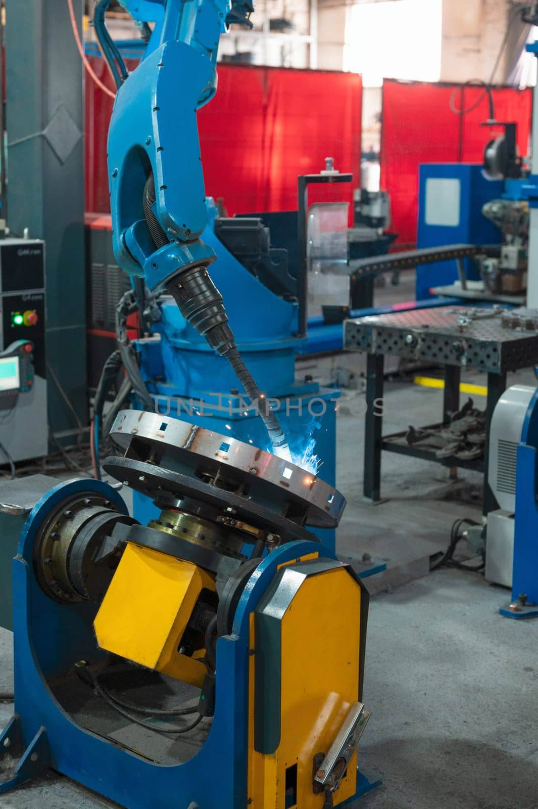Automatic Industrial welding robot in a modern factory in operation.