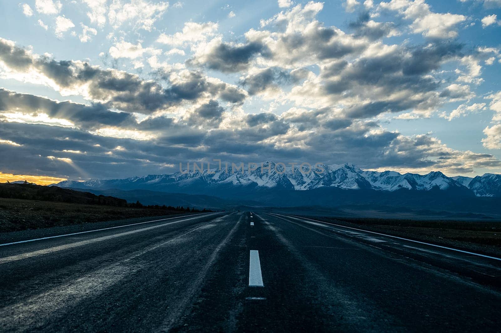 Asphalt road to the mountains. Mountain track on the Altai.