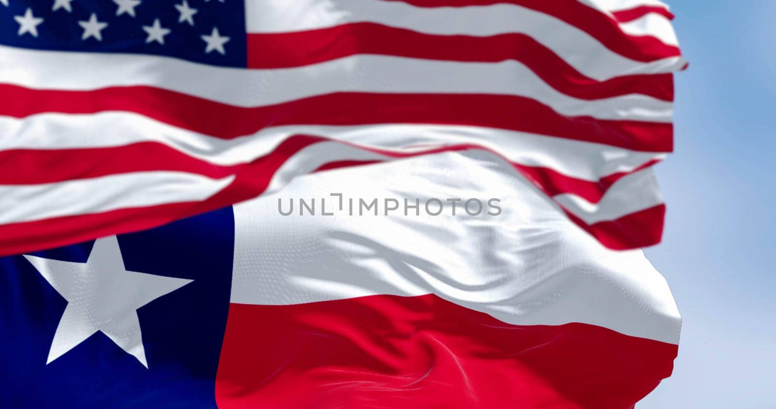 Texas state flags waving in the wind with american flag. Blue vertical stripe with white star, white and red horizontal stripes. 3D illustration render. Fluttering fabric background. Selective focus