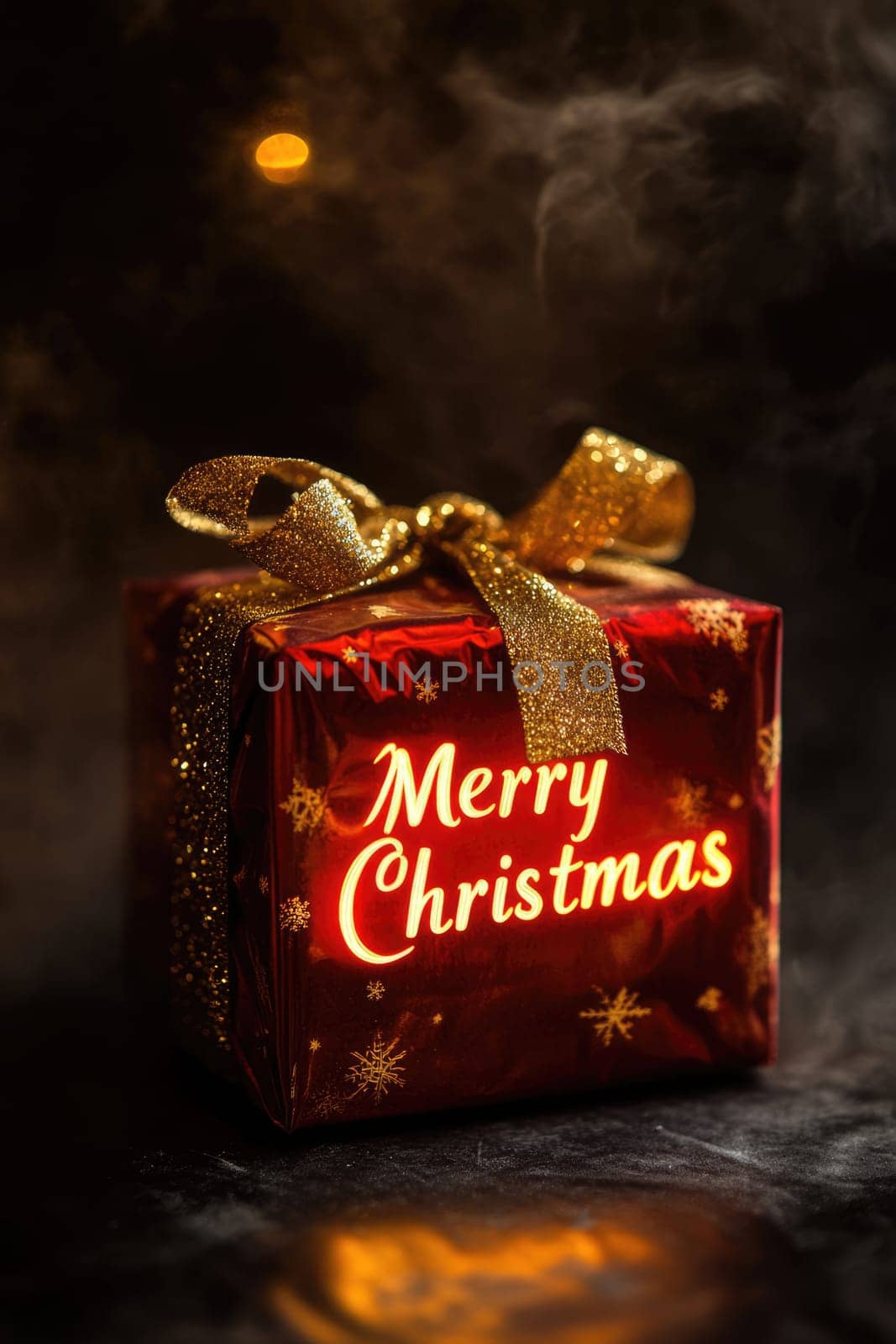 Red gift box with a golden ribbon and glowing neon Merry Christmas text on black background.