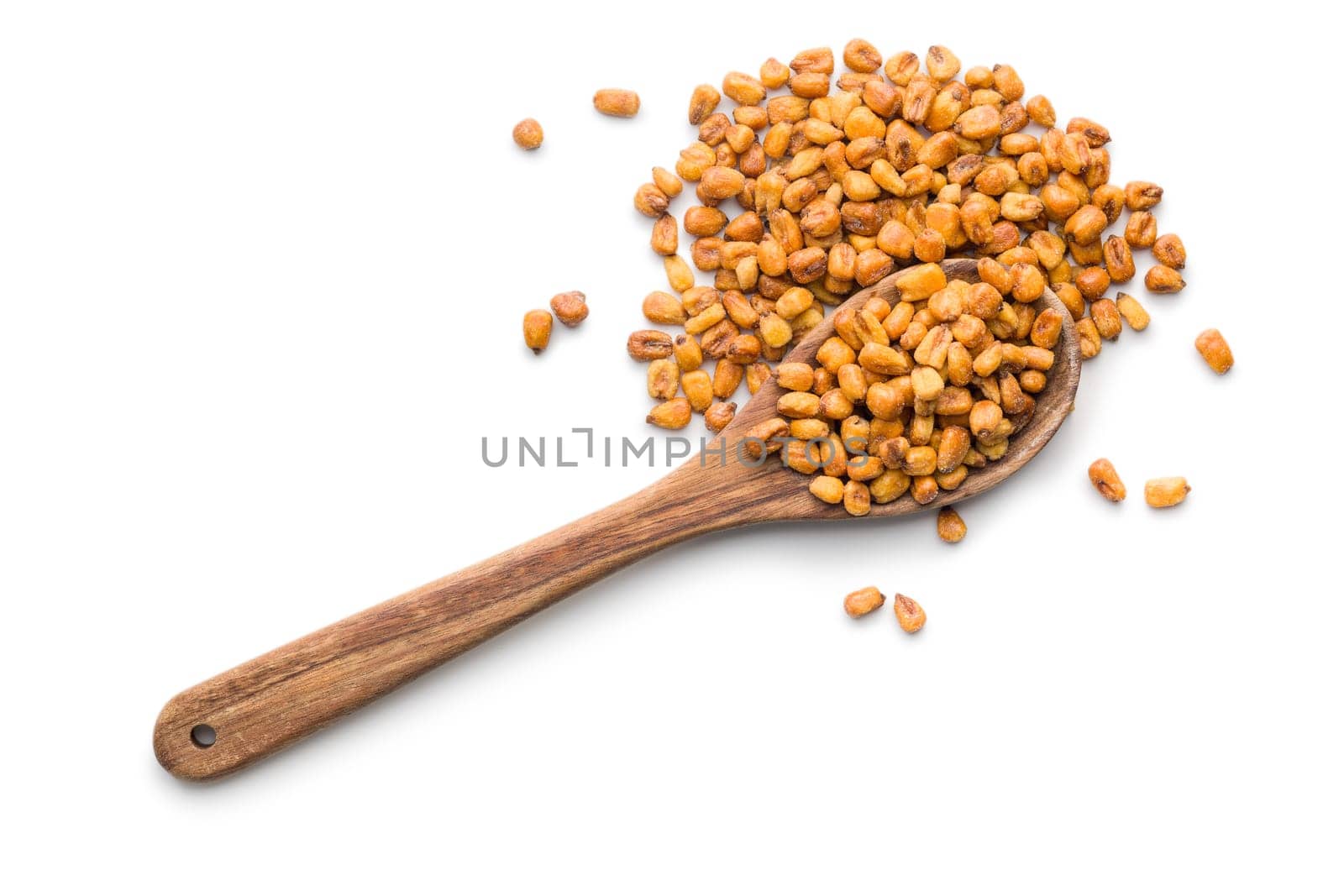 Roasted salted corn snack on wooden spoon isolated on a white background.