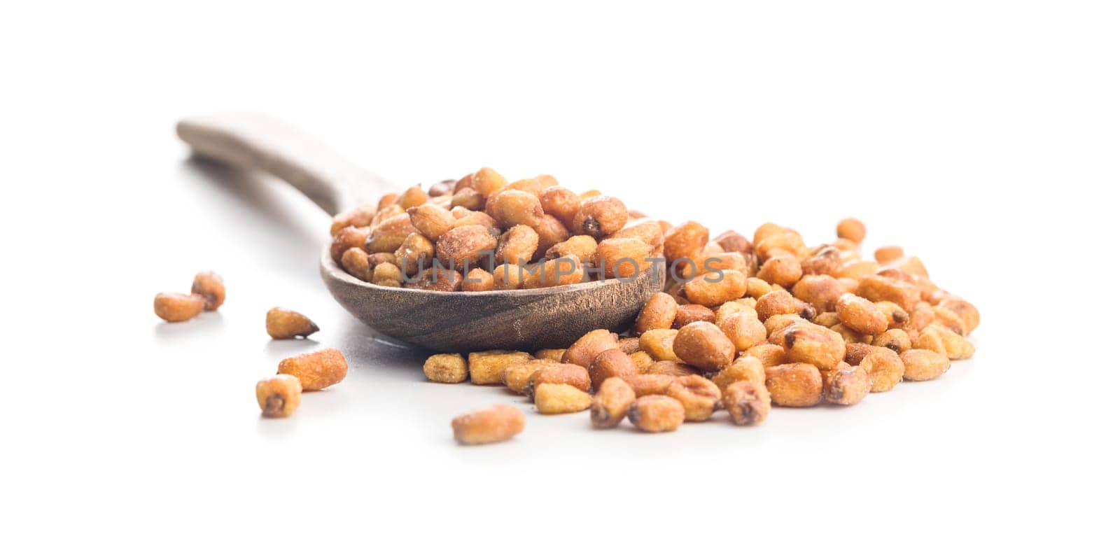 Roasted salted corn snack on wooden spoon isolated on a white background.