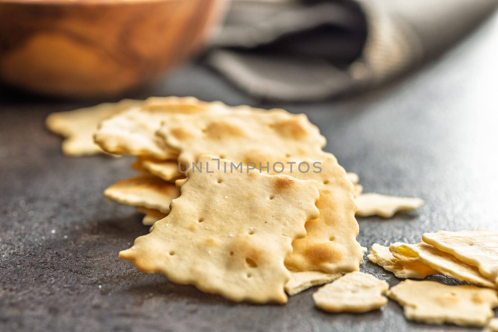 A crispy salted crackers on a black table.