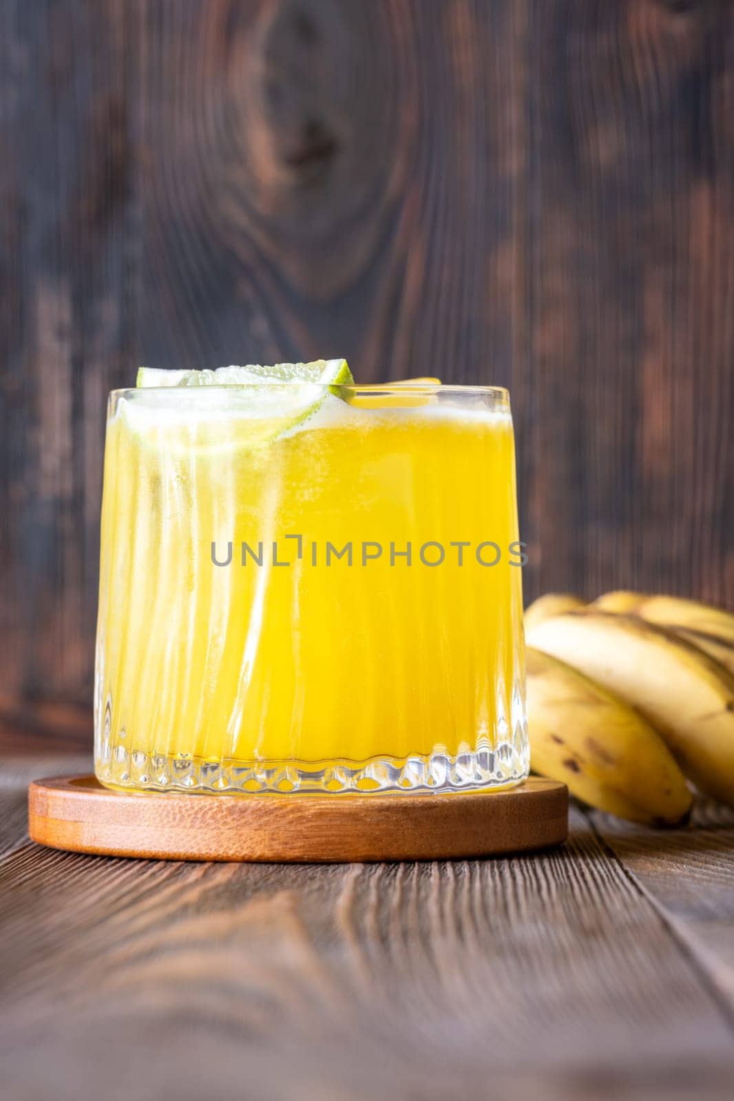 ropical cocktail with banana accents rustic wooden backdrop