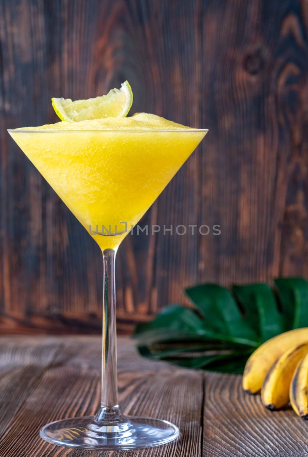 Frozen Banana Daiquiri with lime wedge garnish