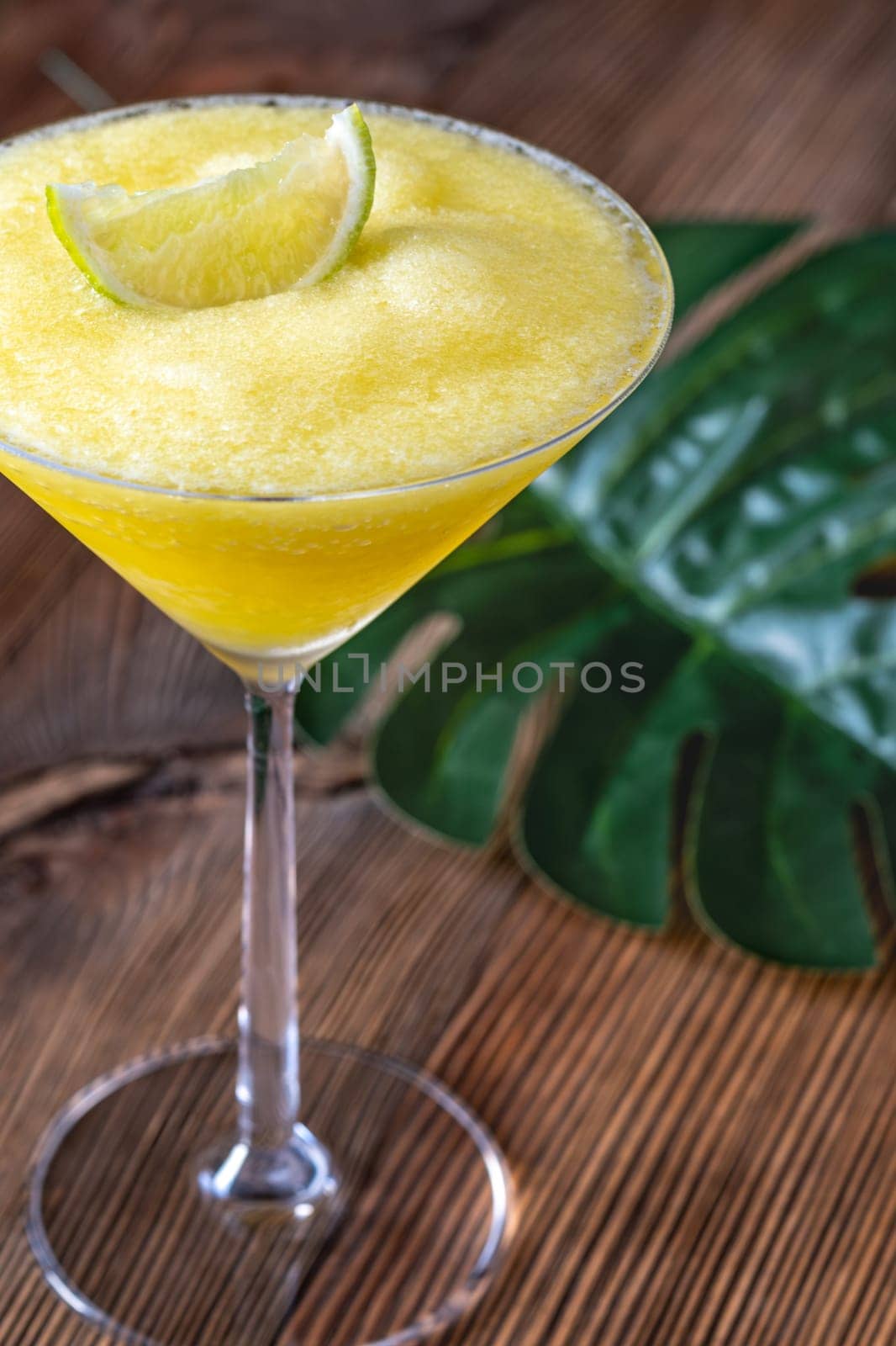 Frozen Banana Daiquiri with lime wedge garnish